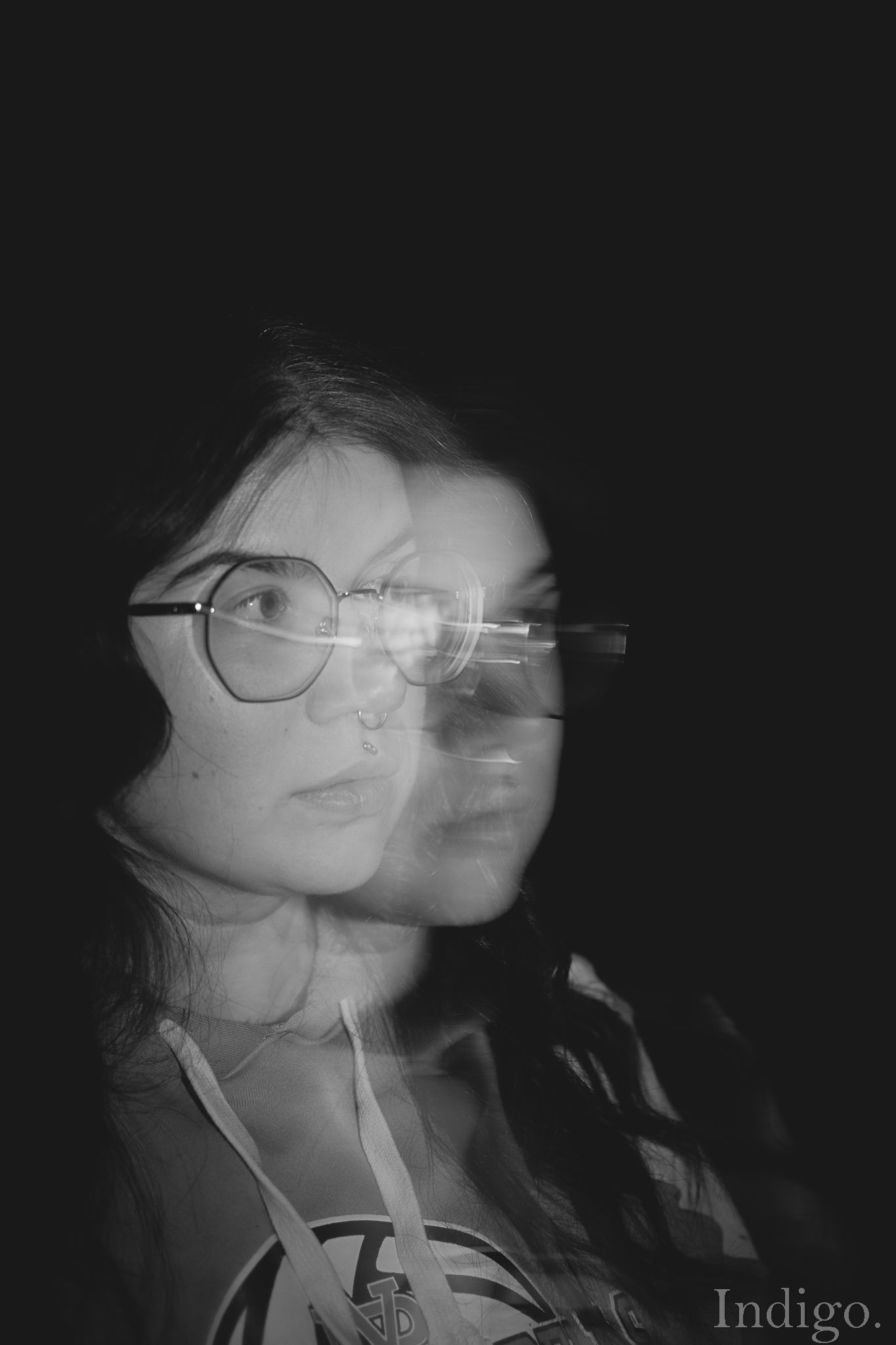 Double exposure black and white portrait showing motion and ethereal effects.