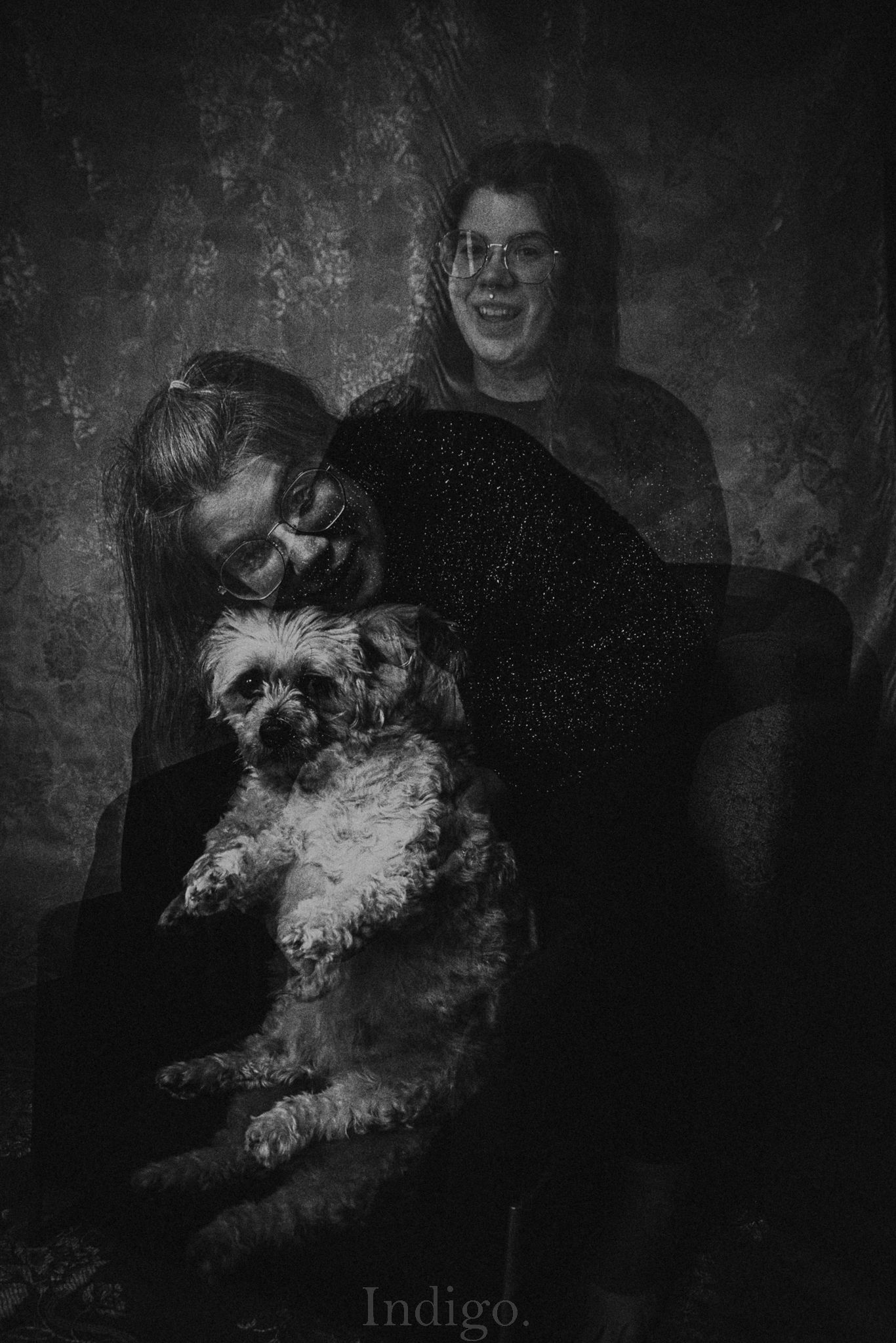 Black and white photograph of a fluffy white dog against a dark textured background.