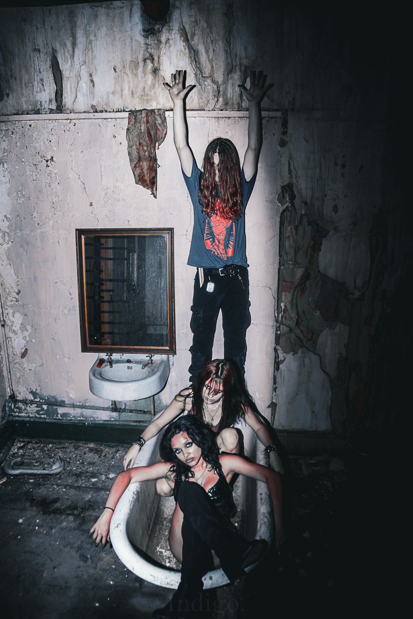 Artistic photoshoot in abandoned building with dramatic poses and lighting.