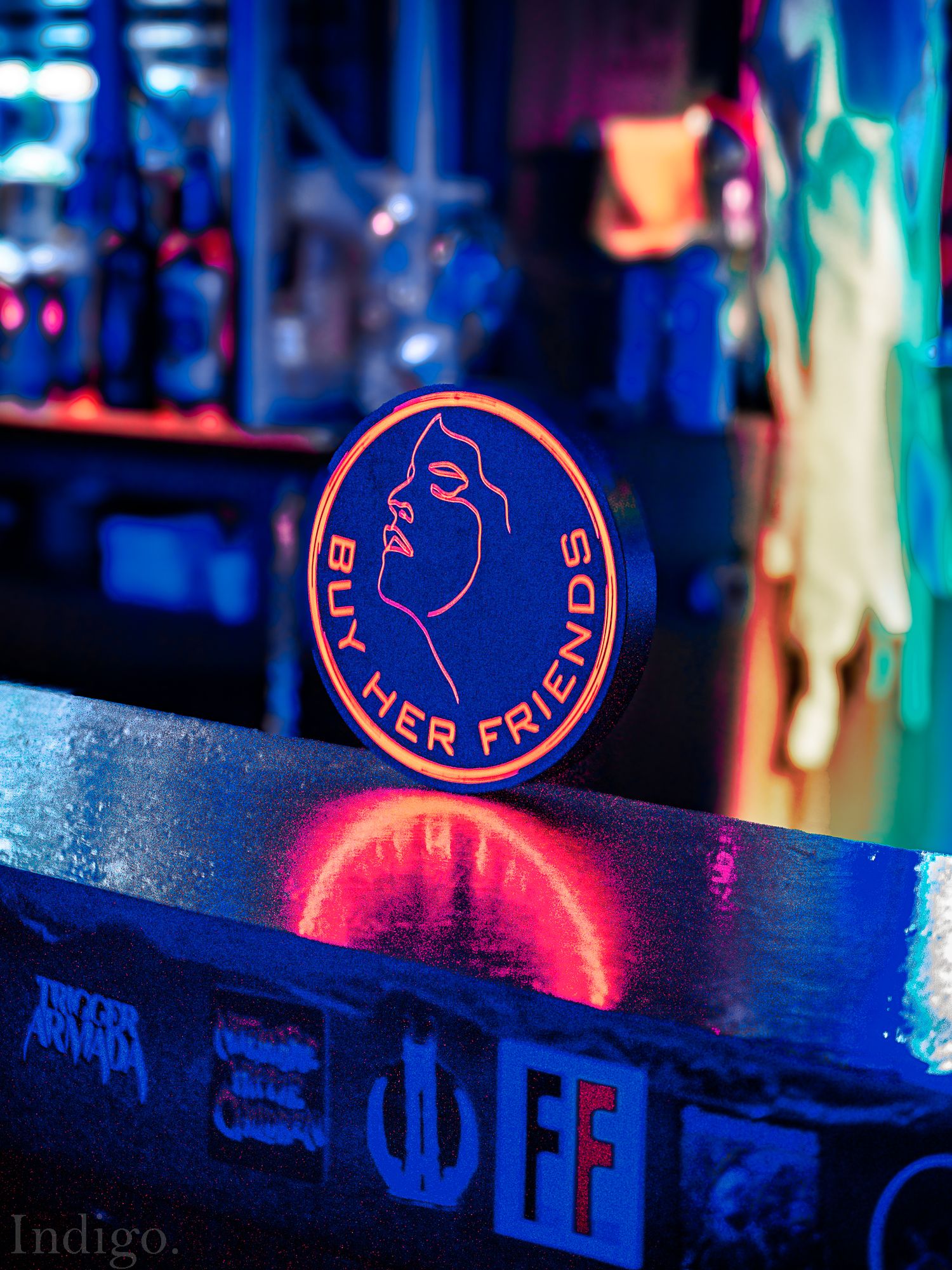 Neon red bar sign glowing in dark nightclub atmosphere with blurred background lighting effects.