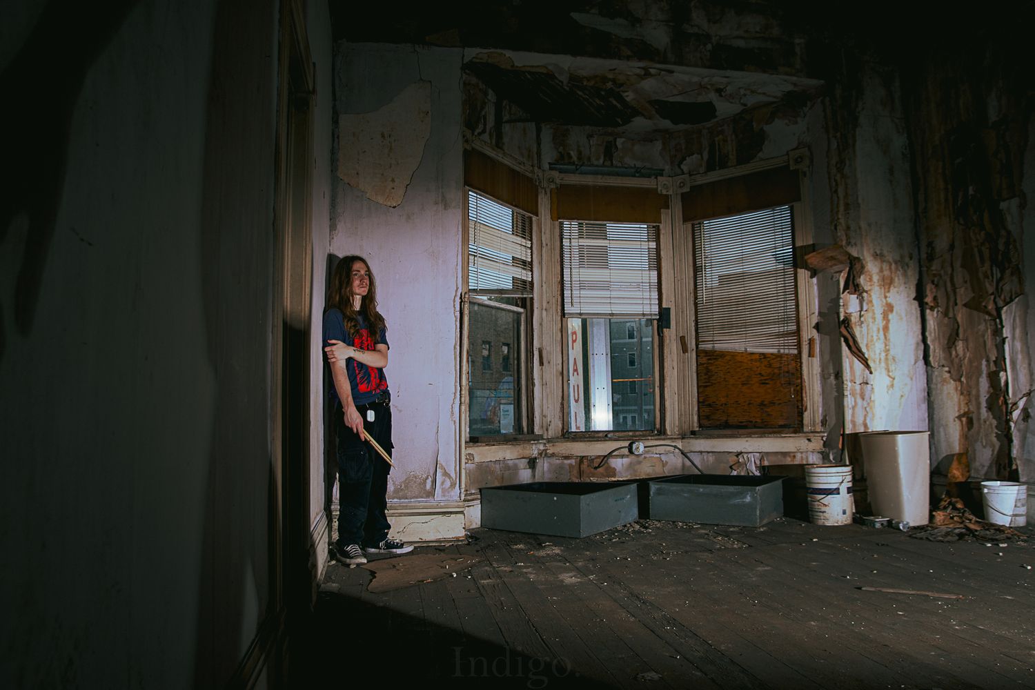 Dark panoramic view of an abandoned interior space with dramatic shadows.