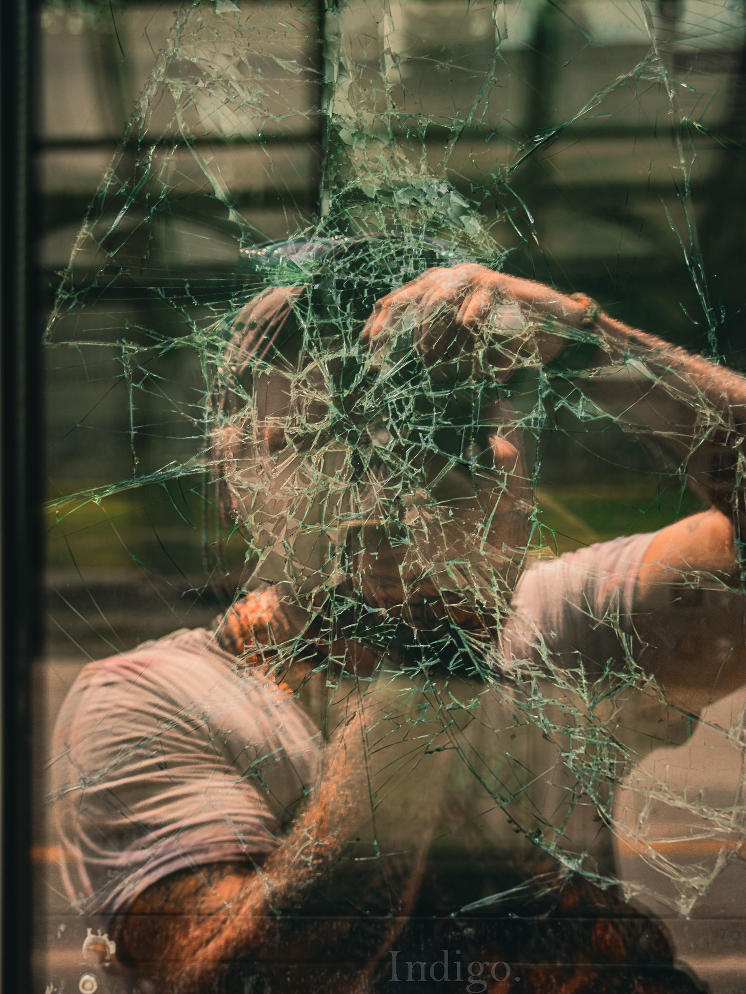 Abstract image showing shattered glass or spider web patterns with warm tones.