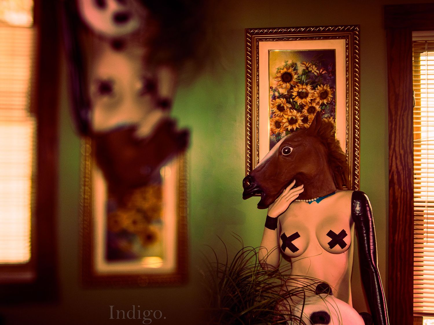 Interior room with warm lighting and framed artwork on walls creating cozy ambiance.