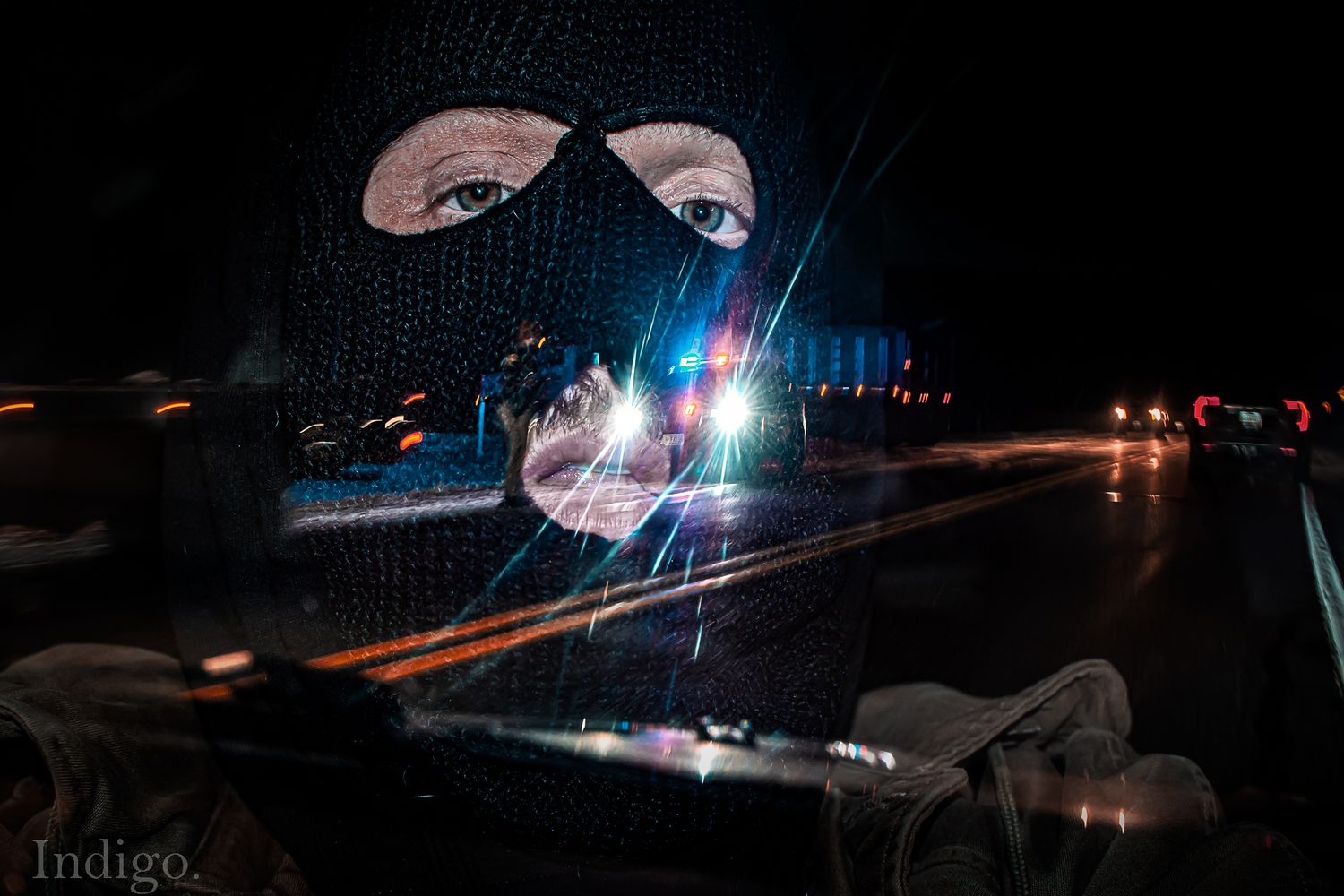 Long exposure night photography with light trails and reflections on dark background.