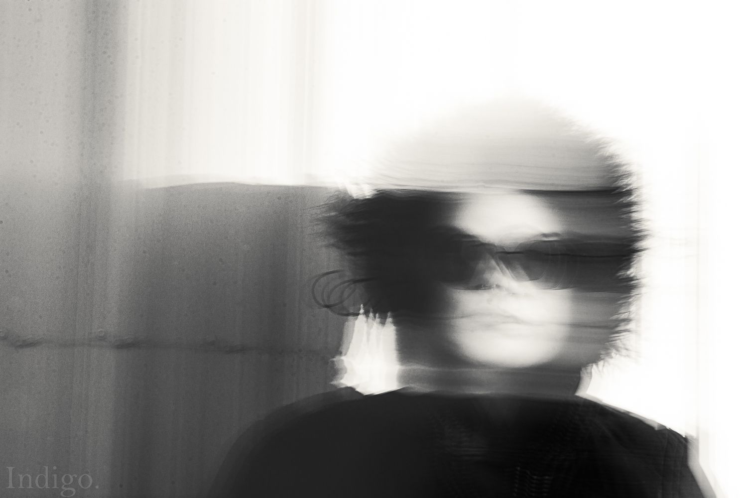 Blurred black and white portrait creating an abstract motion effect.