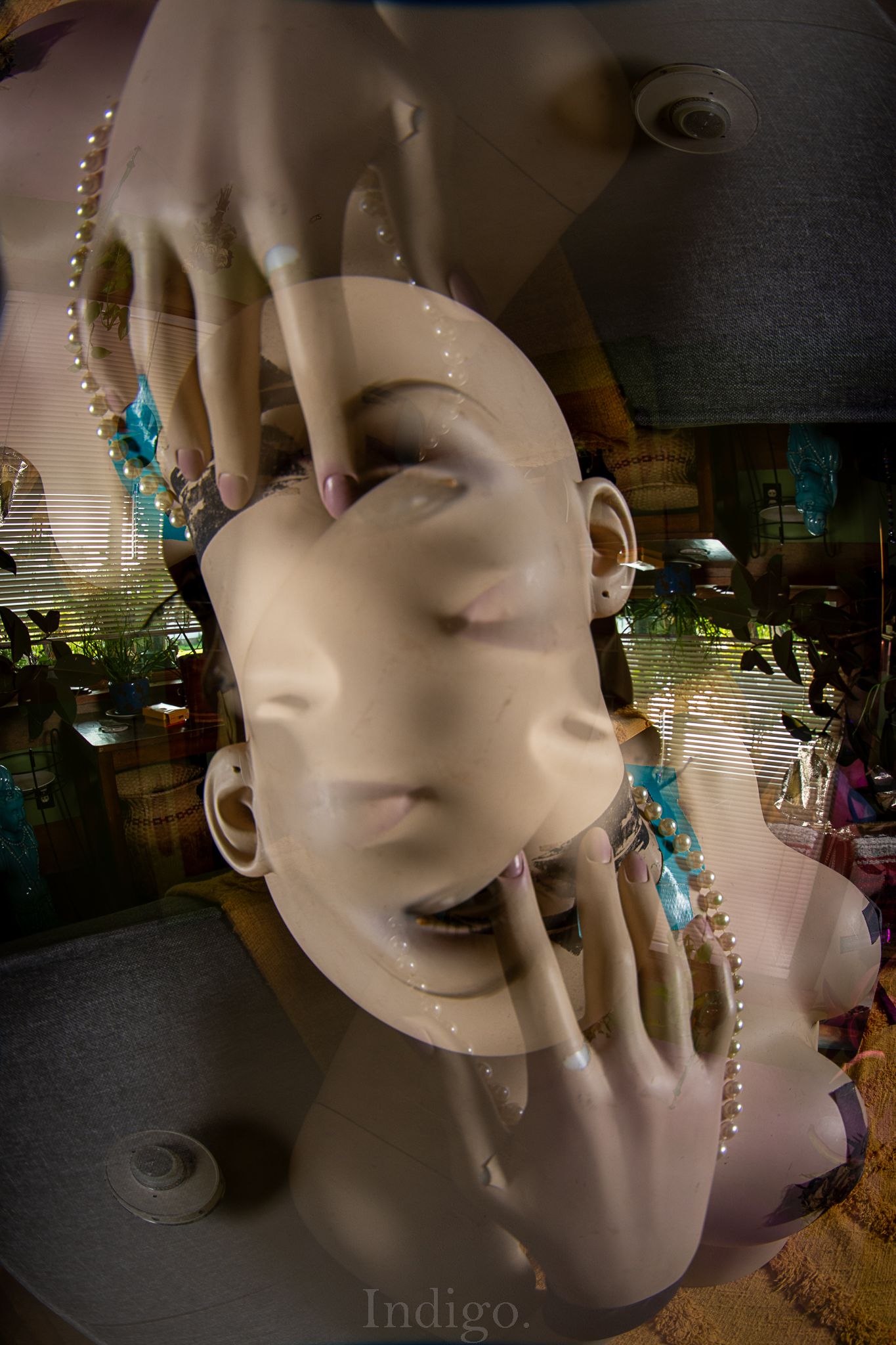 Double exposure of a mannequin head with crystal decorations and turquoise accents.