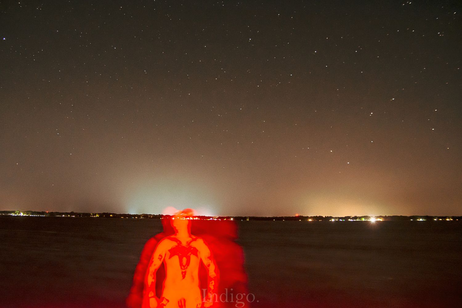 Stunning timelapse of a sunset over a lake with glowing orange and purple hues in the sky.