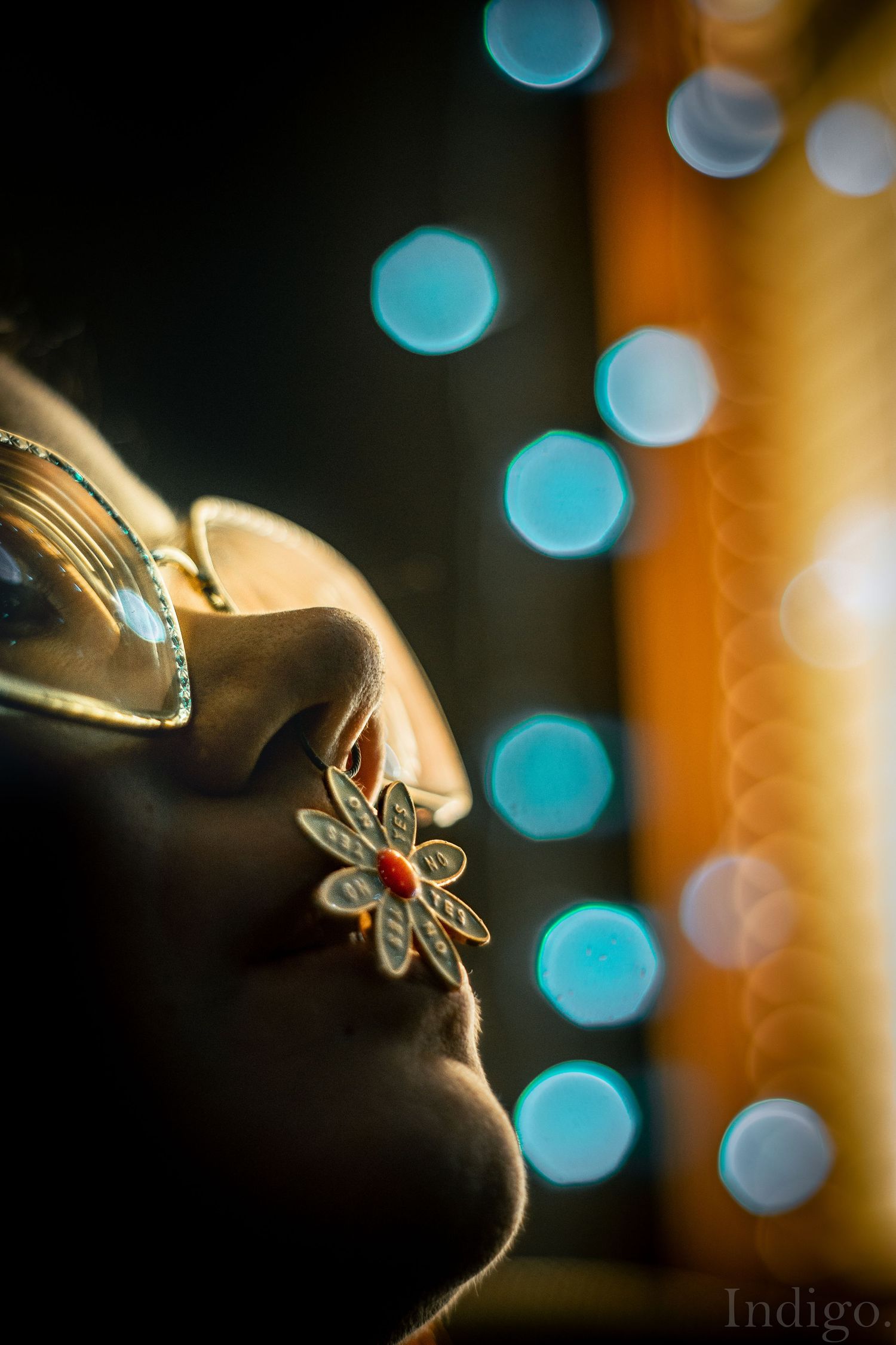 Macro shot of delicate jewelry with dragonfly charm against bokeh background.