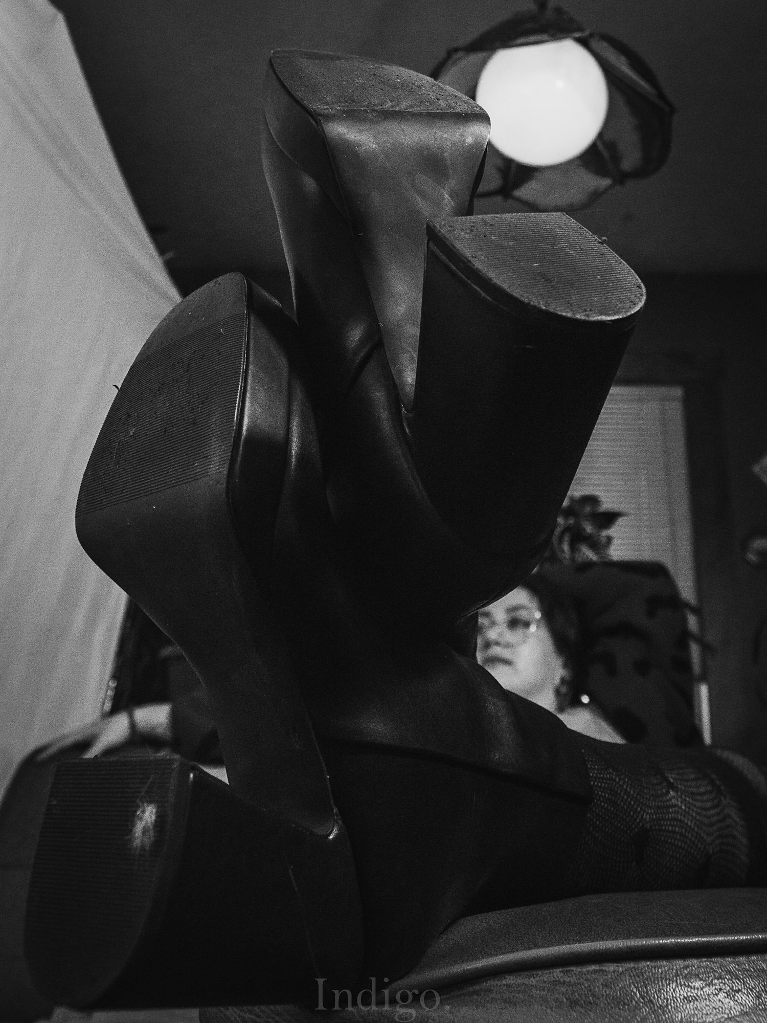 Black and white close-up photograph of cymbals in a dimly lit setting creating a moody musical atmosphere.