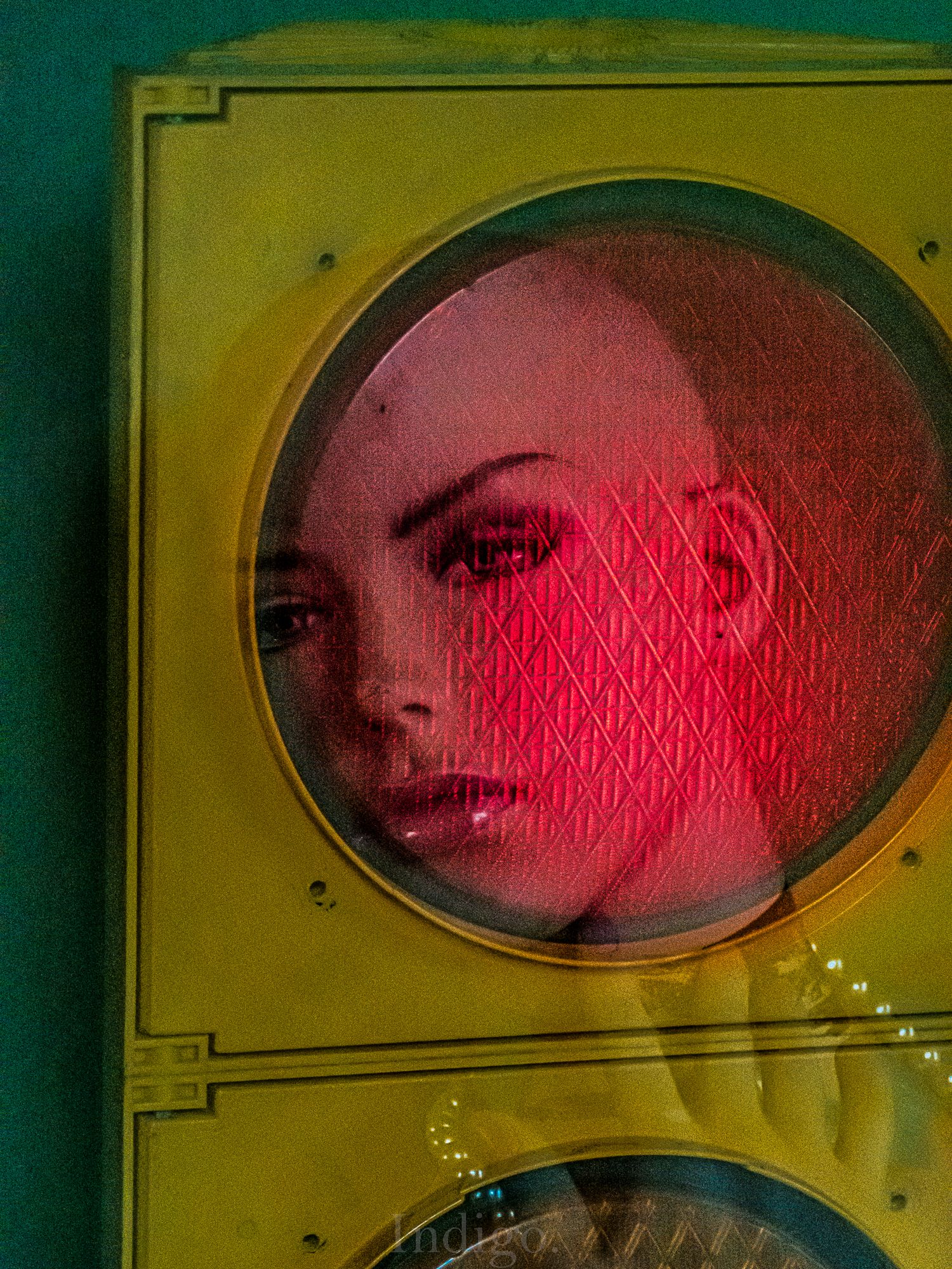 A series of oval-framed portraits in yellow frames showing a pink-tinted artistic progression from left to right.