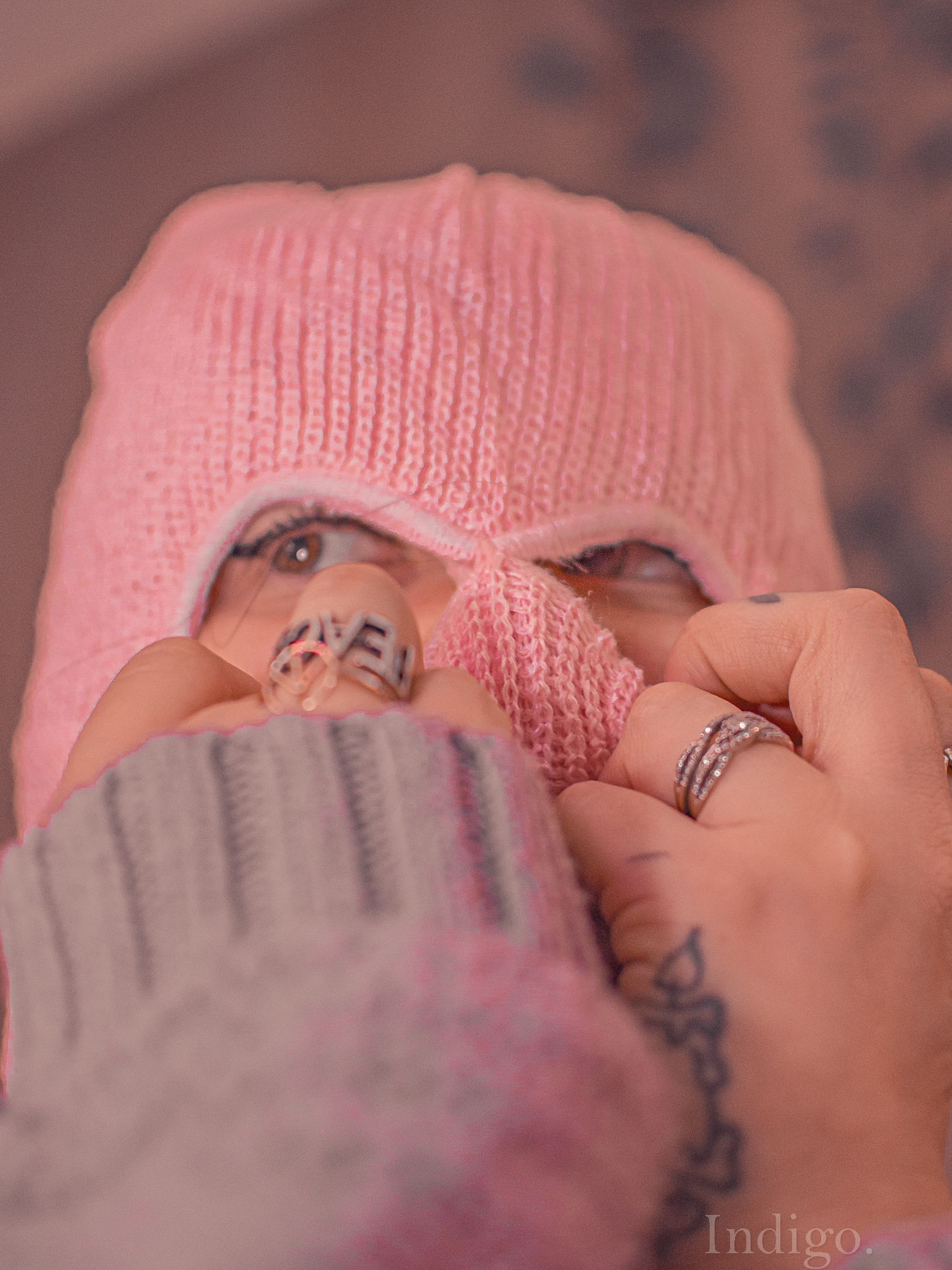 Close-up macro photography of pink knitted fabric texture with shallow depth of field.