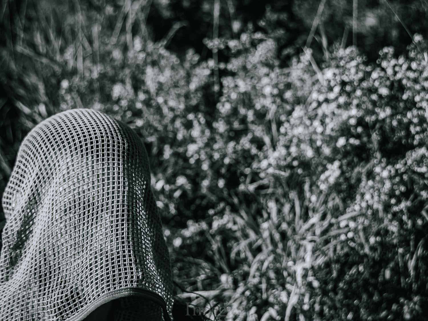 Black and white portrait series showing a knitted mask with glasses creating a mysterious artistic effect.