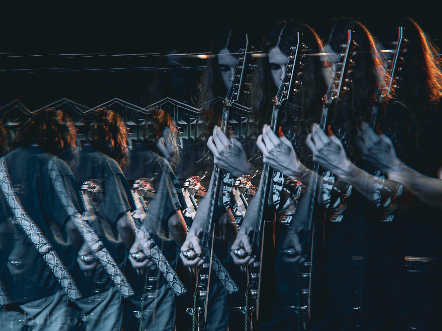 Multiple exposure concert photo creating ghosting effect in monochromatic tones.