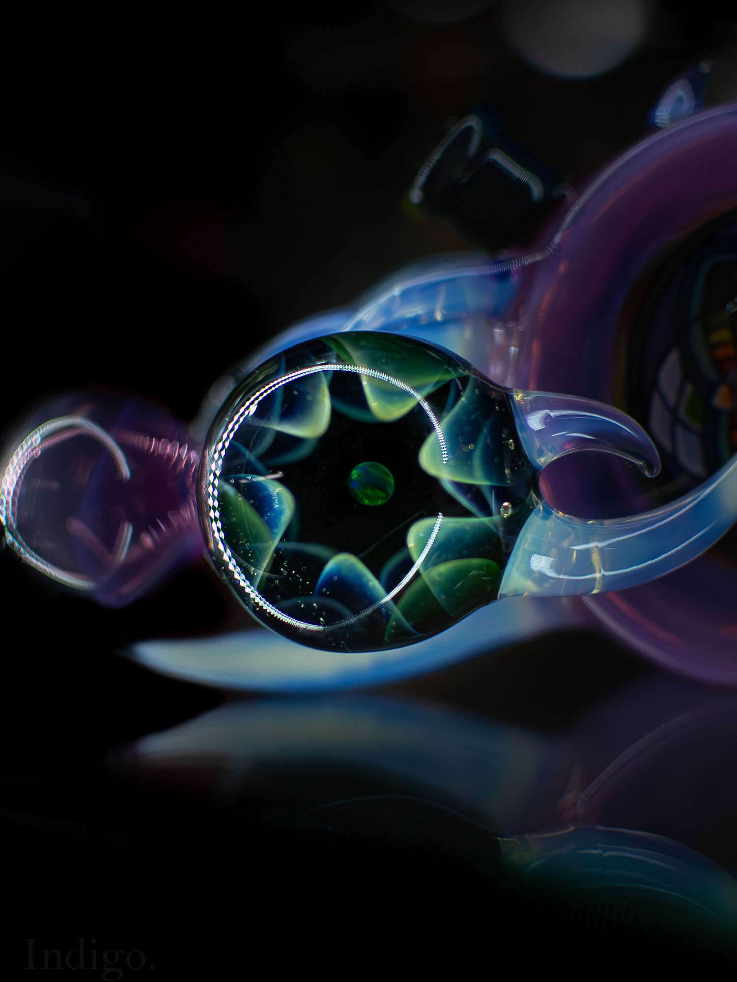 Artistic close-up of sunglasses reflecting light with purple and blue tones in dark background.