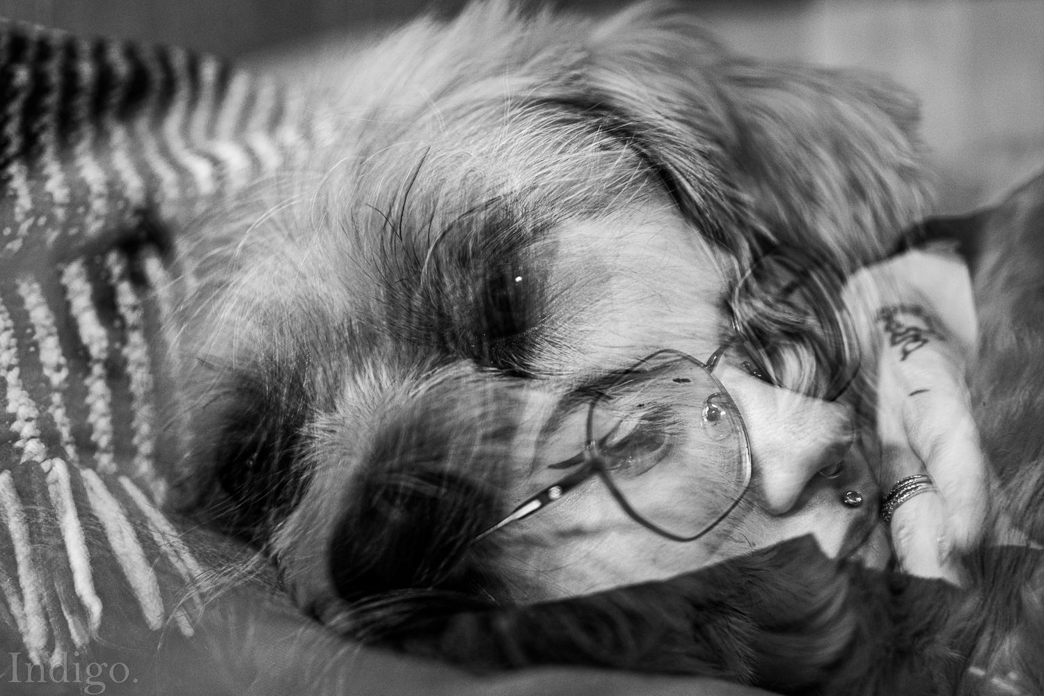 Artistic black and white portrait with venetian blind shadows.