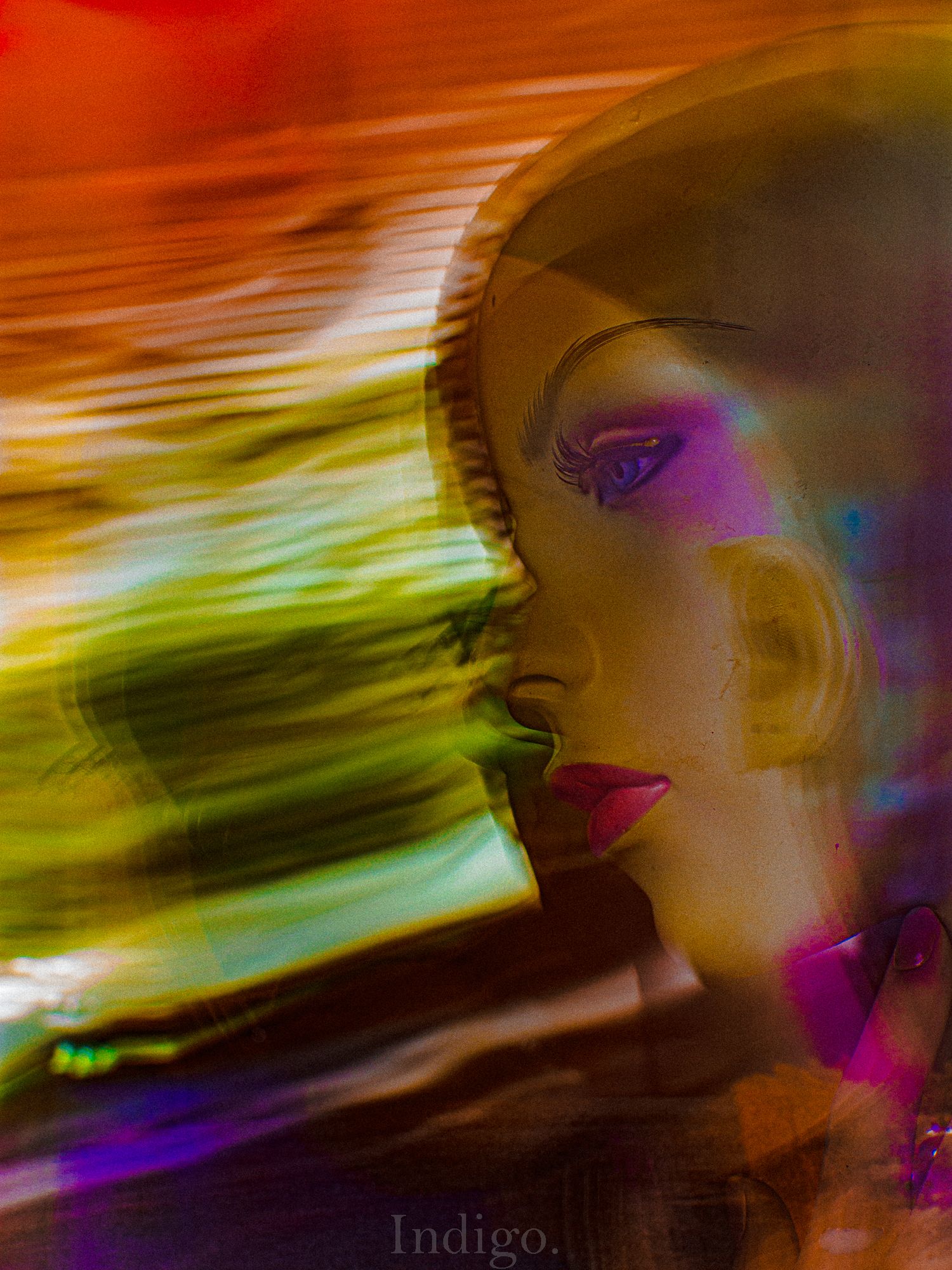 Abstract art with swirling colors of orange, green, and purple creating a dynamic motion effect.