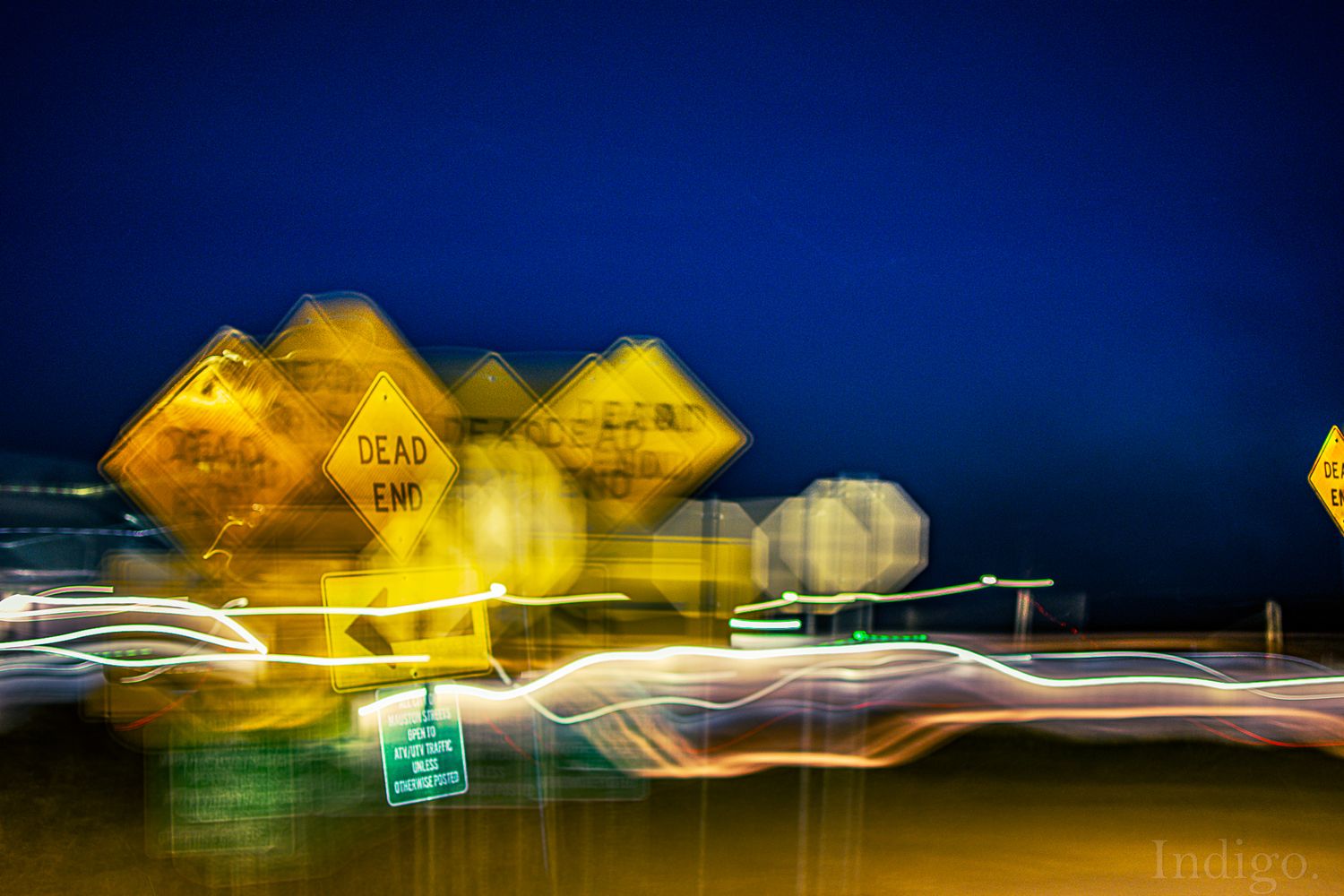 Motion-blurred highway scene at night with streaking yellow lights.