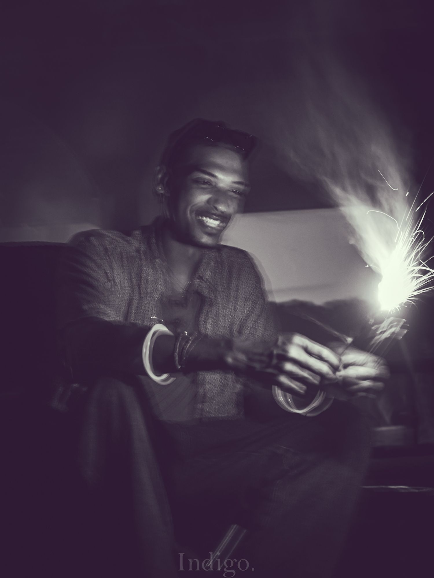 Black and white photo of someone playing with light painting effects in the darkness.