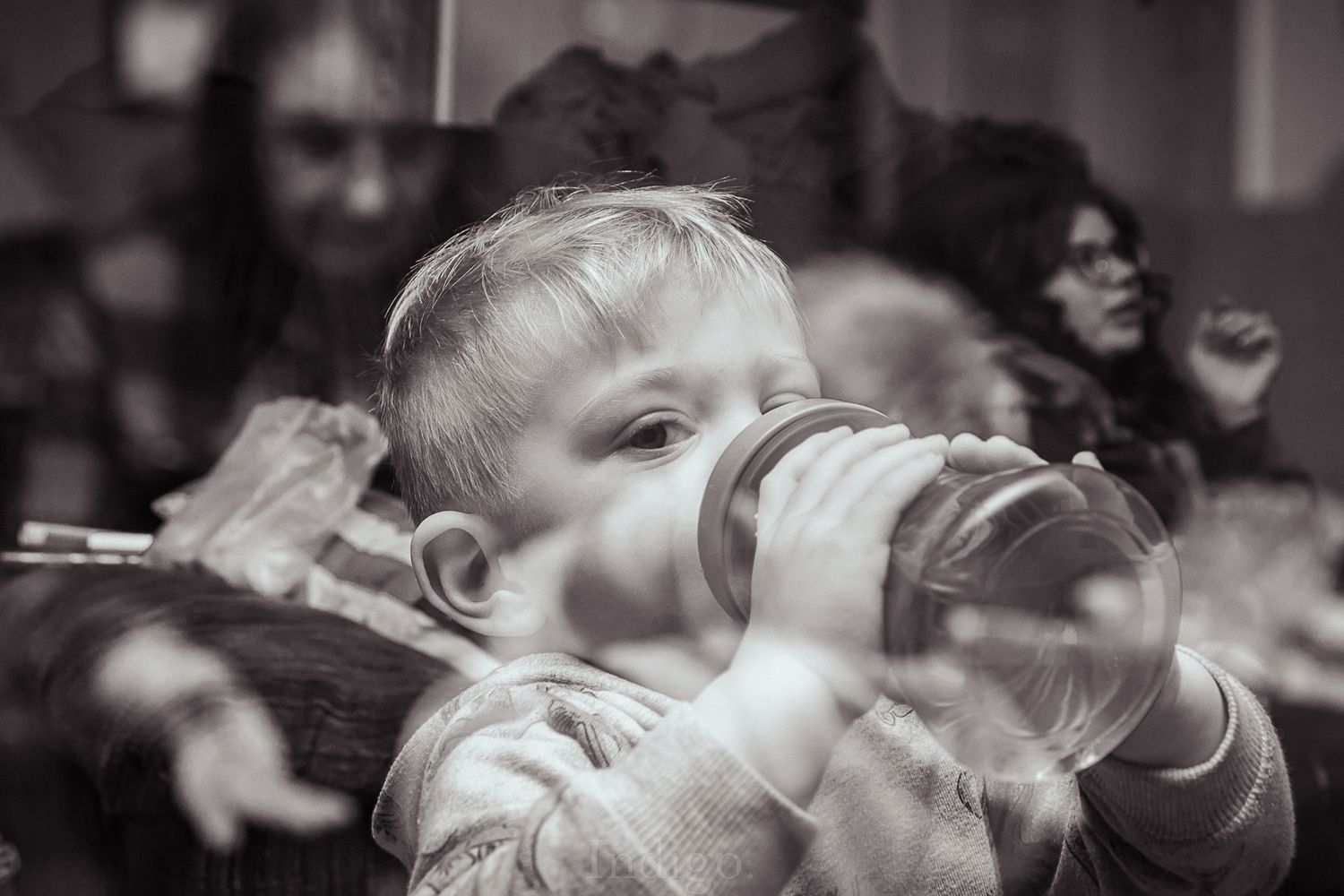 Black and white motion blur photograph capturing movement in a crowd.