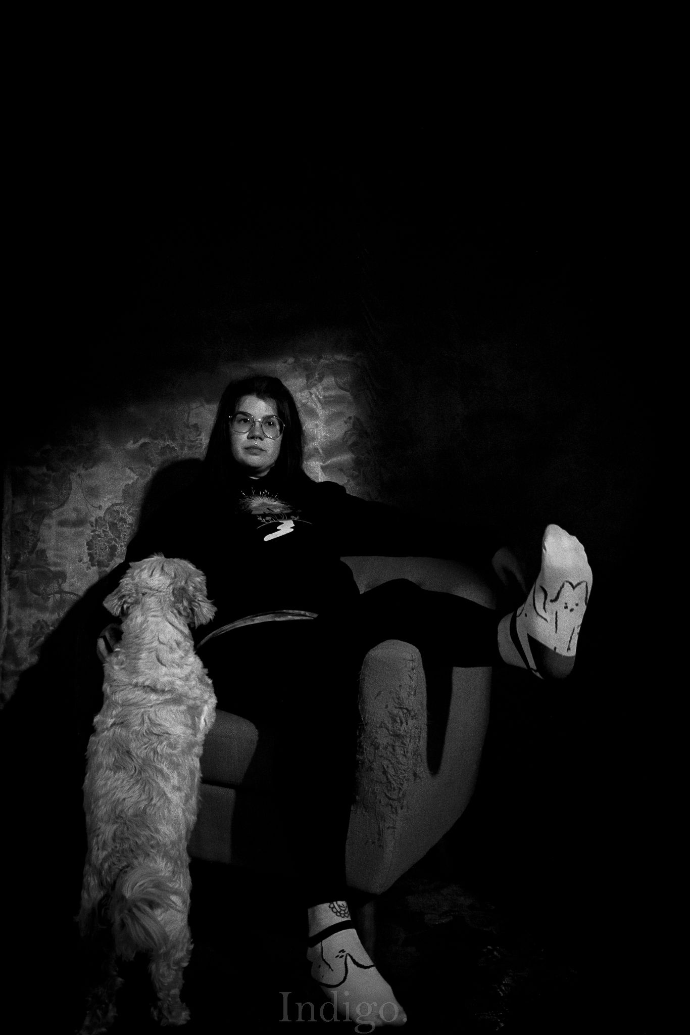 Dramatic black and white silhouettes against a textured wall with stark lighting.
