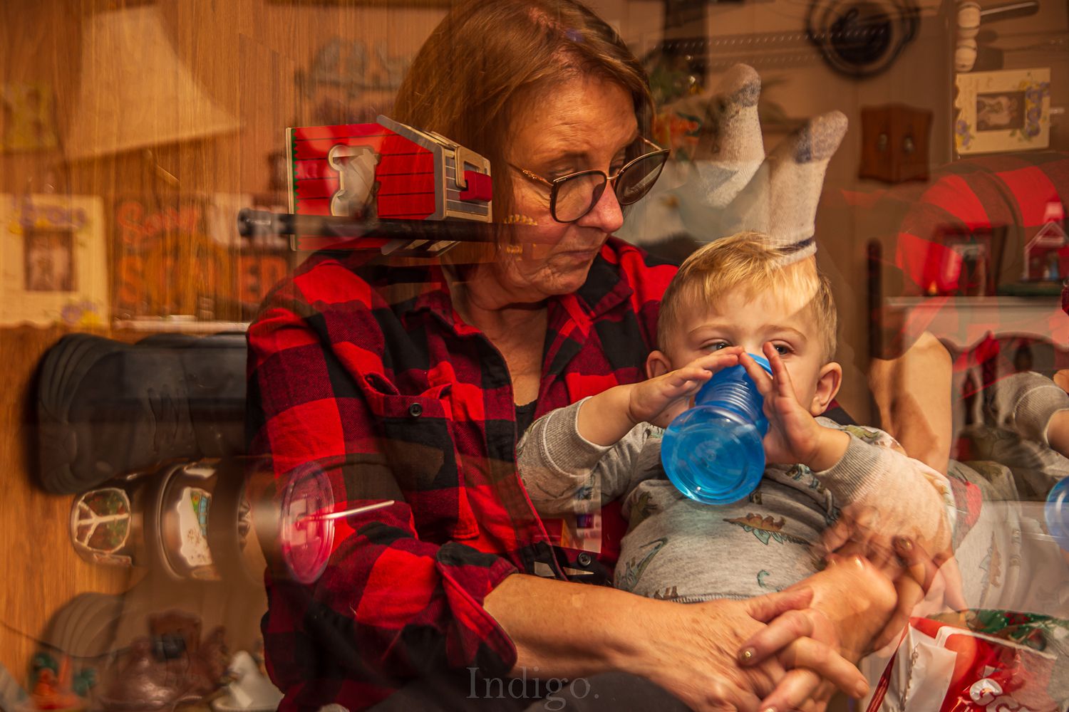 Family moment captured in warm indoor lighting with plaid shirt and casual atmosphere.