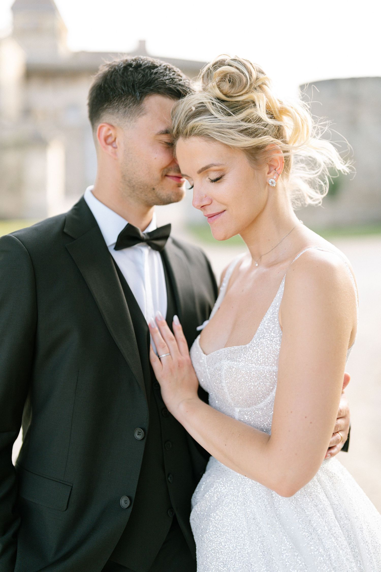 A romantic wedding couple shares intimate moments in a series of elegant black and white formal portraits.