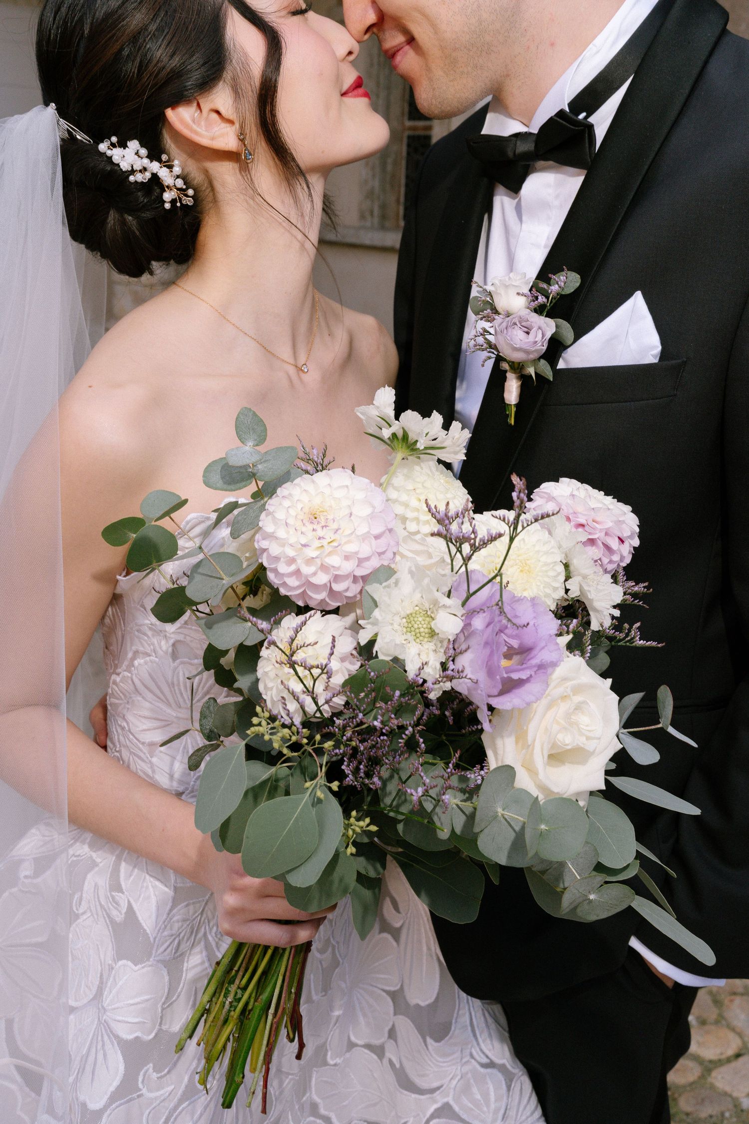 Close-up wedding portraits with elegant pastel bouquet featuring roses and eucalyptus.