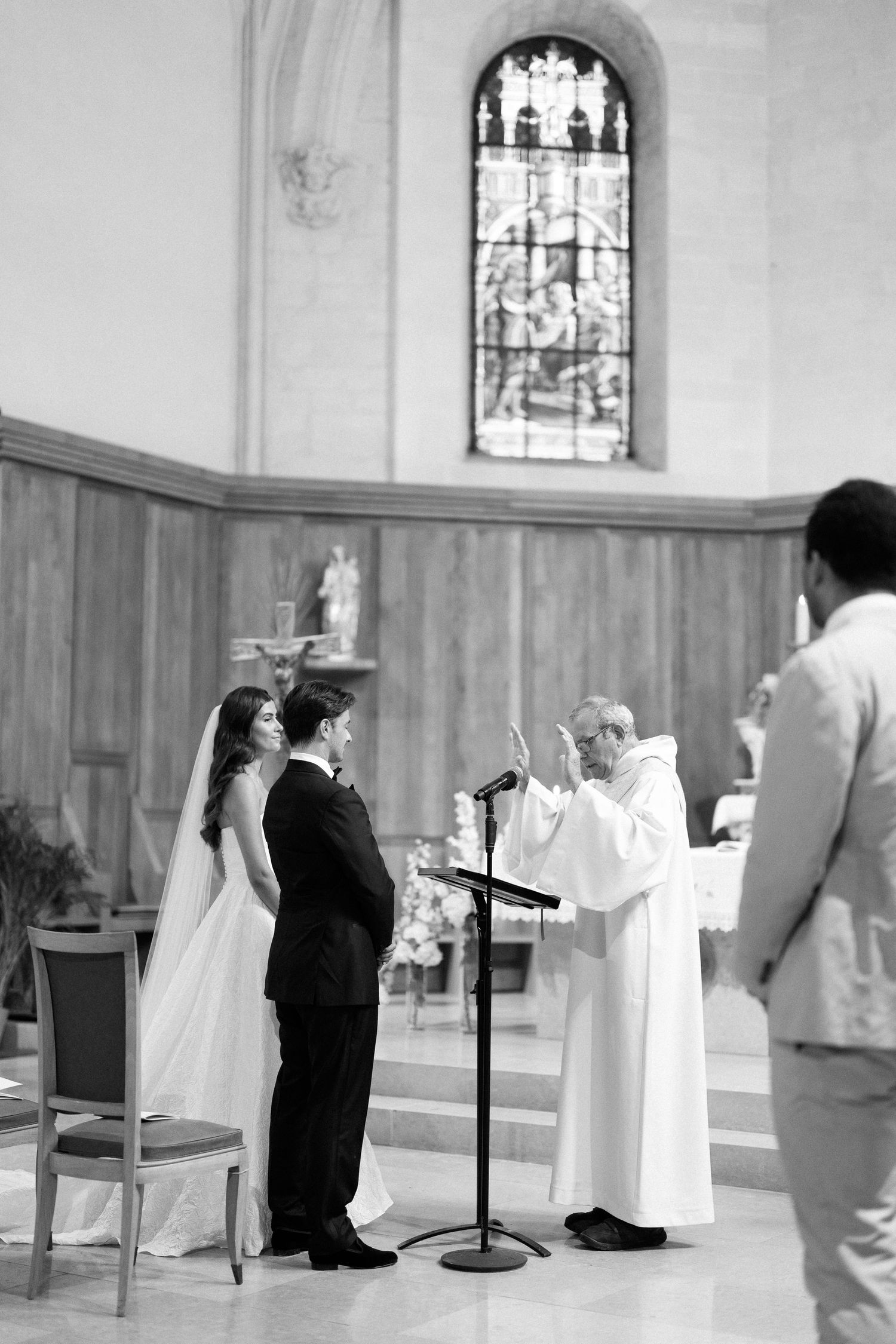 A traditional Catholic wedding ceremony takes place in a church with priests in white robes.