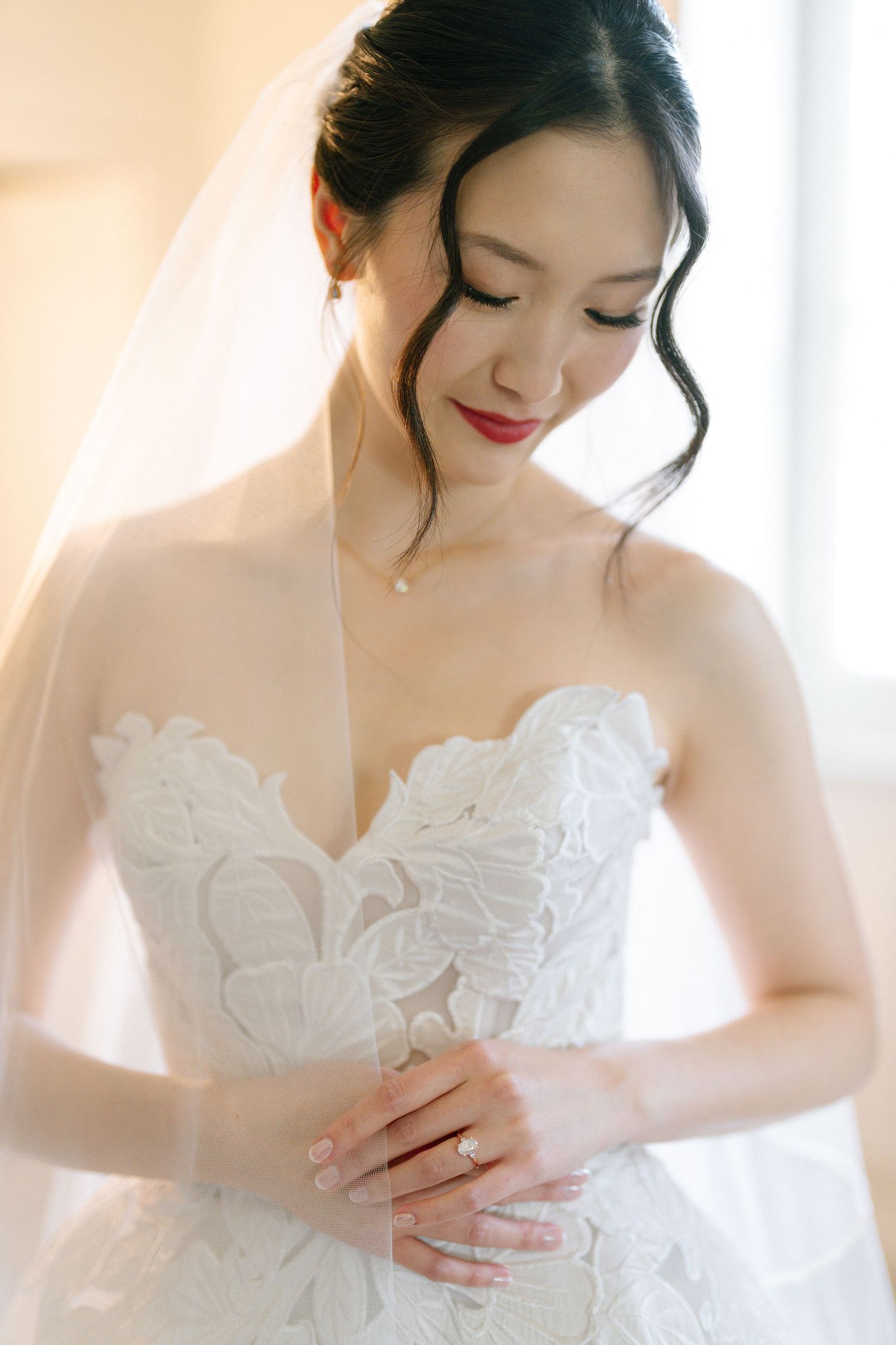 Close-up shots of a delicate white lace wedding dress with intricate details and embroidery.