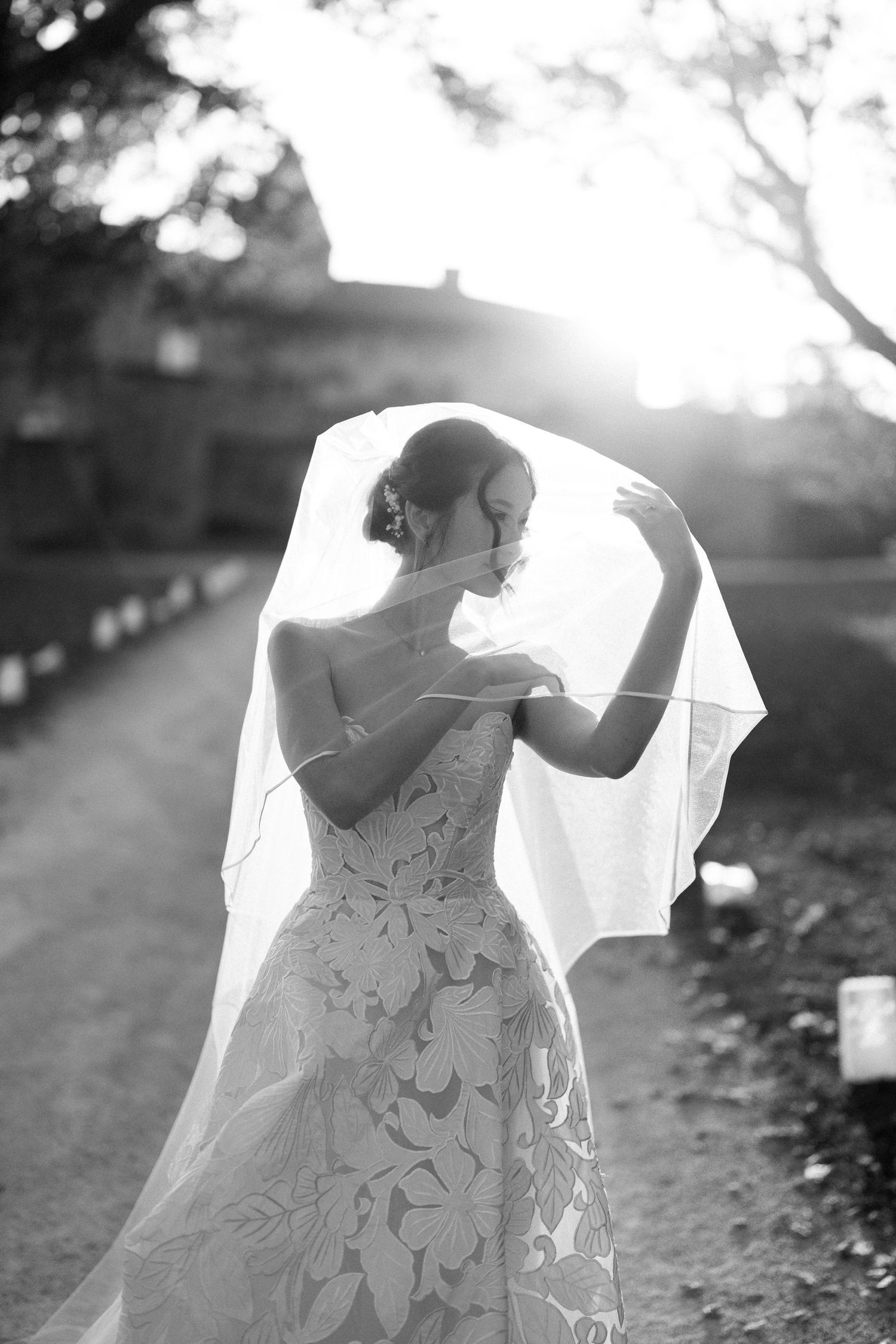 Artistic black and white shots of a flowing wedding dress in natural outdoor lighting.