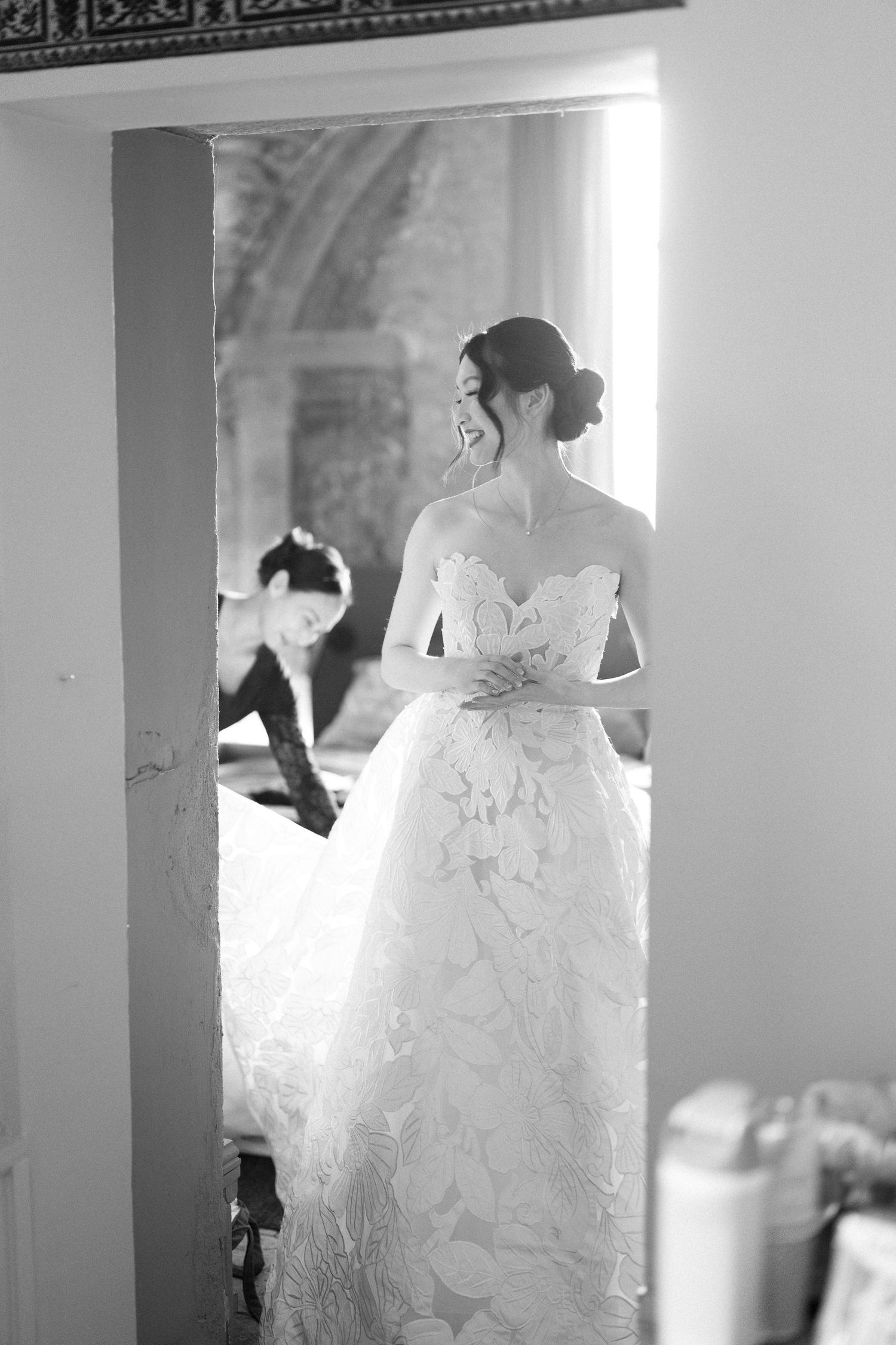 Black and white sequence showing the elegant silhouette of a wedding dress against natural light.