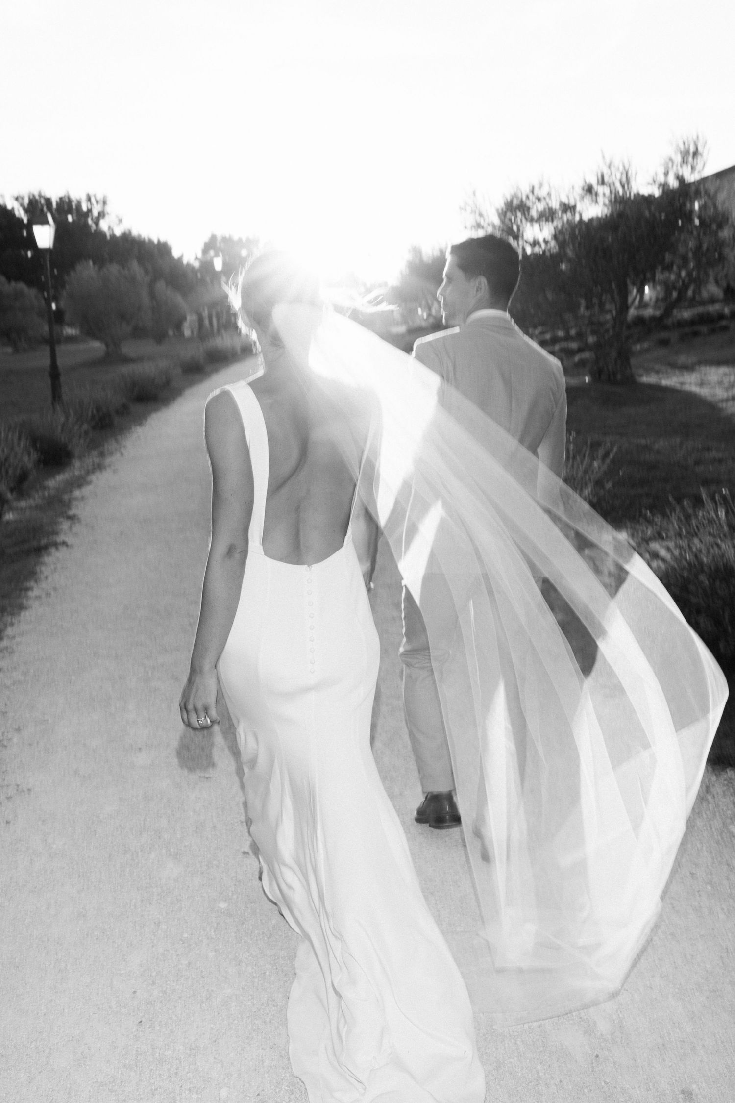 Black and white sequence of flowing wedding dress movement on a path.