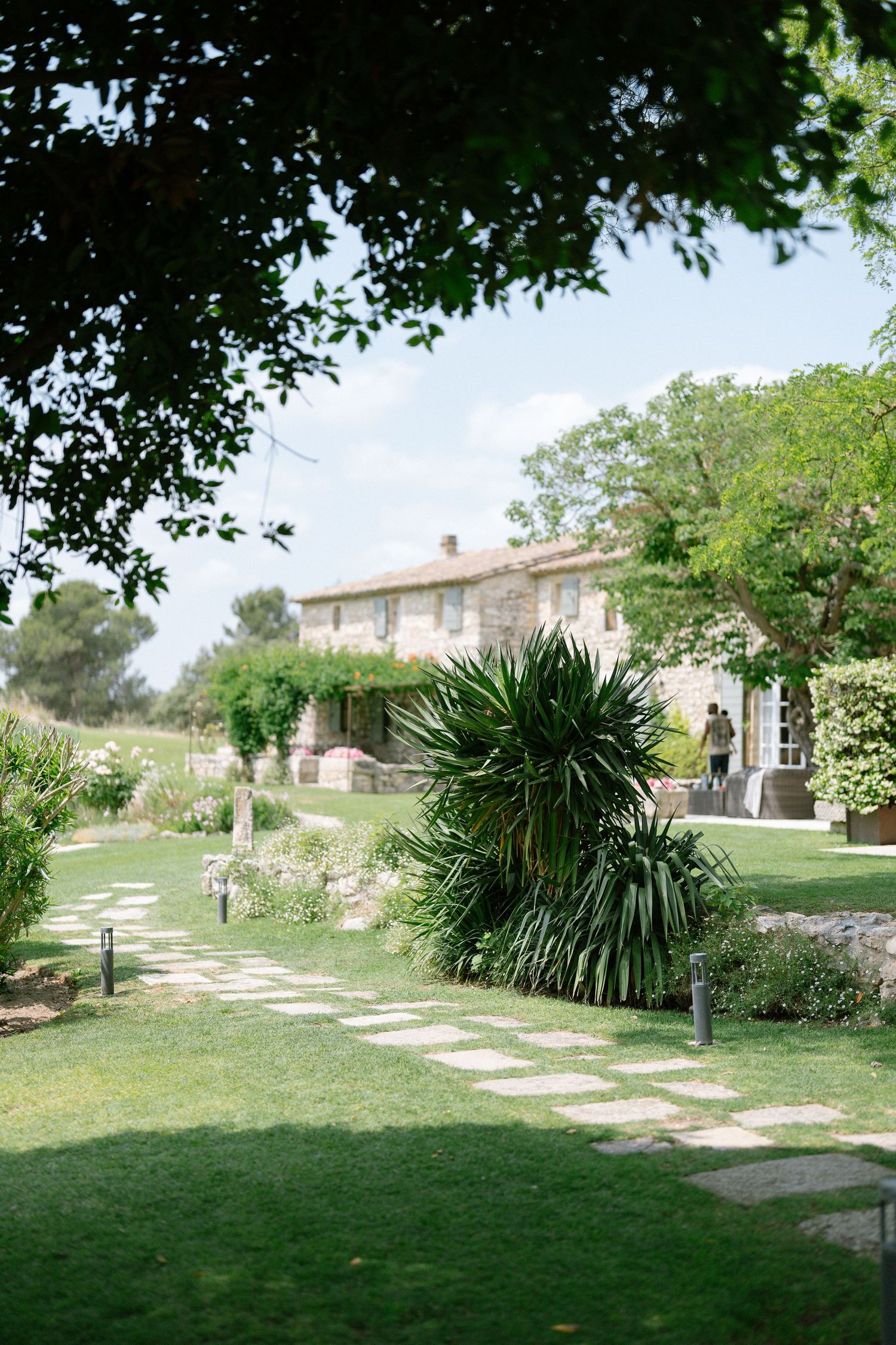 Scenic garden pathway with stone walkway and lush greenery at an elegant venue.
