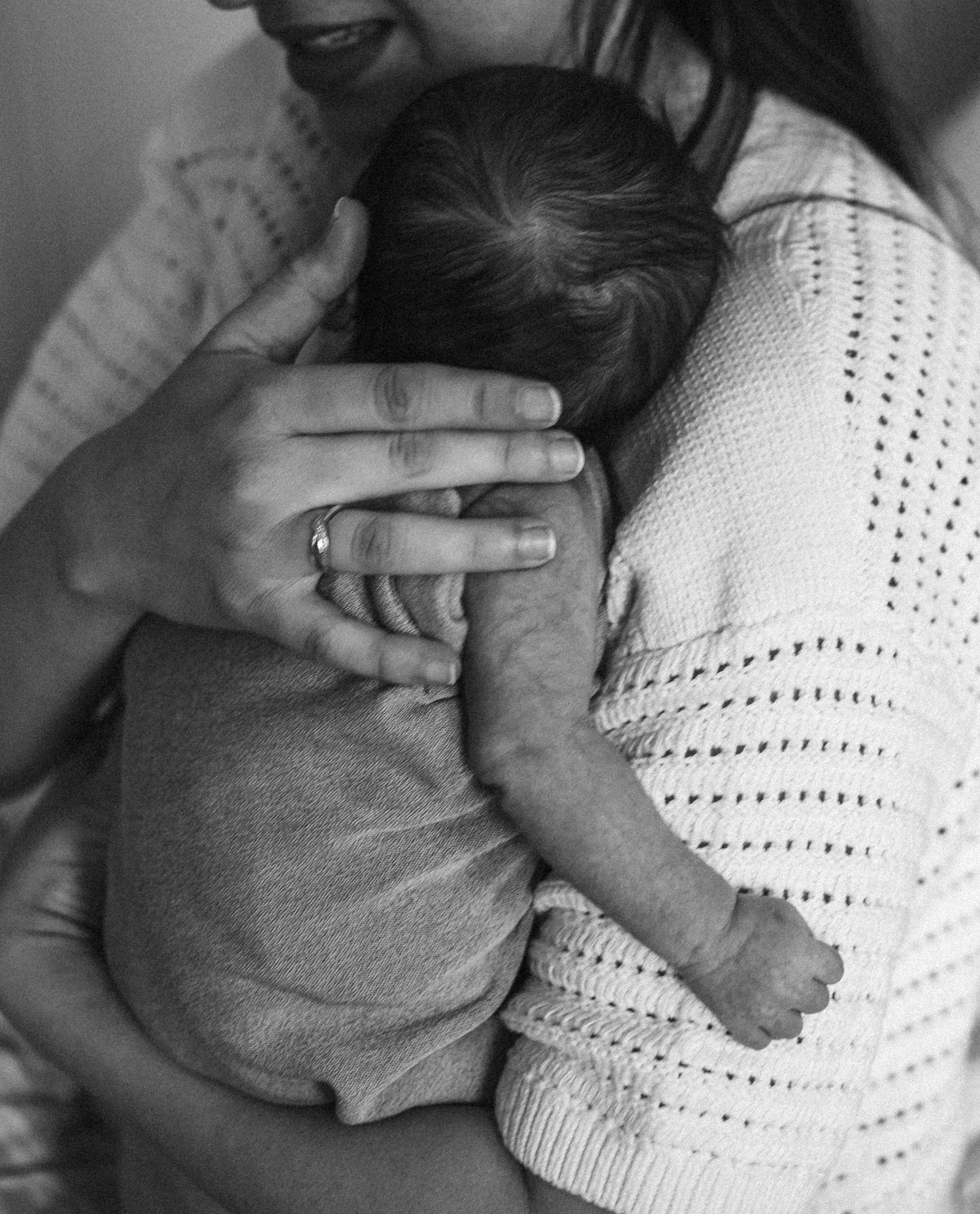 Oakville photographer capturing newborn baby in mom's arm