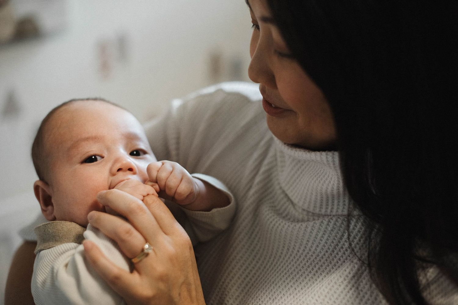 Lifestyle newborn photography in Oakville capturing baby in parent’s arms