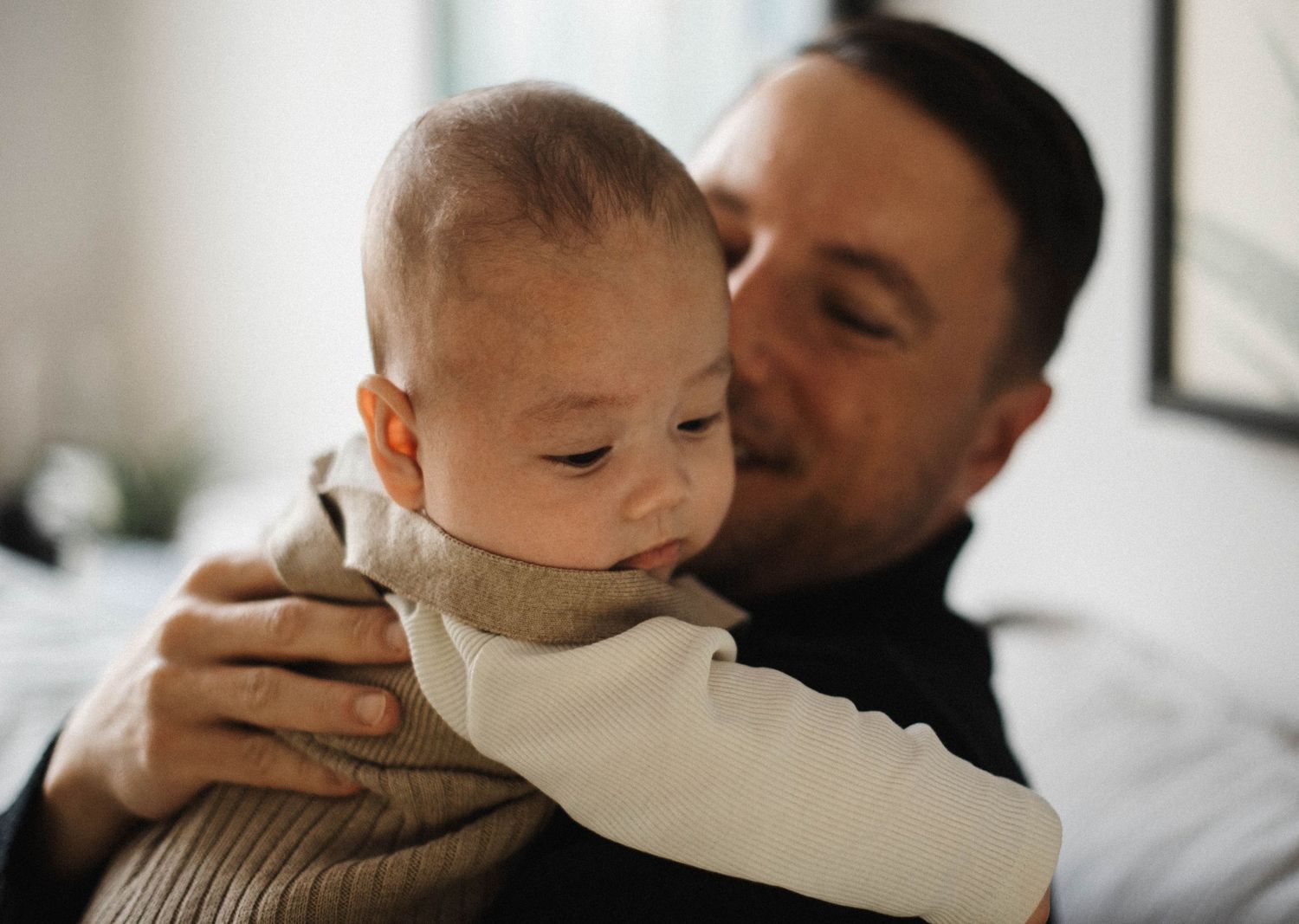 Father holding his baby during an in-home lifestyle photography session in Oakville