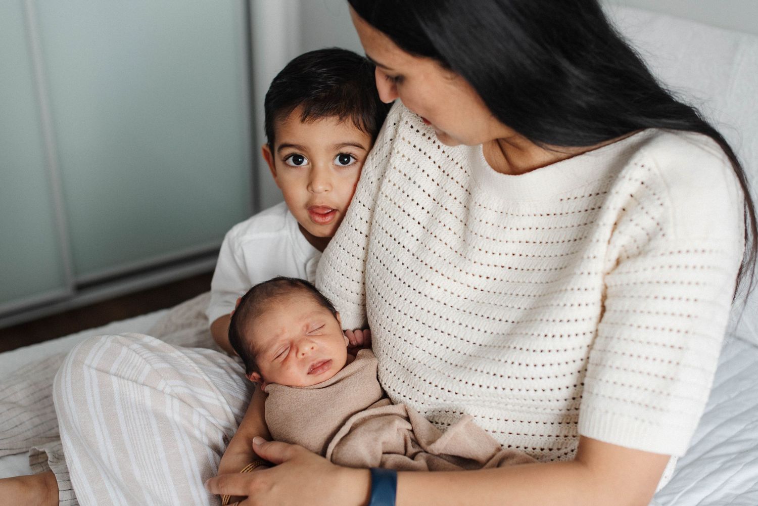 Mississauga lifestyle newborn photographer capturing mother and baby indoors