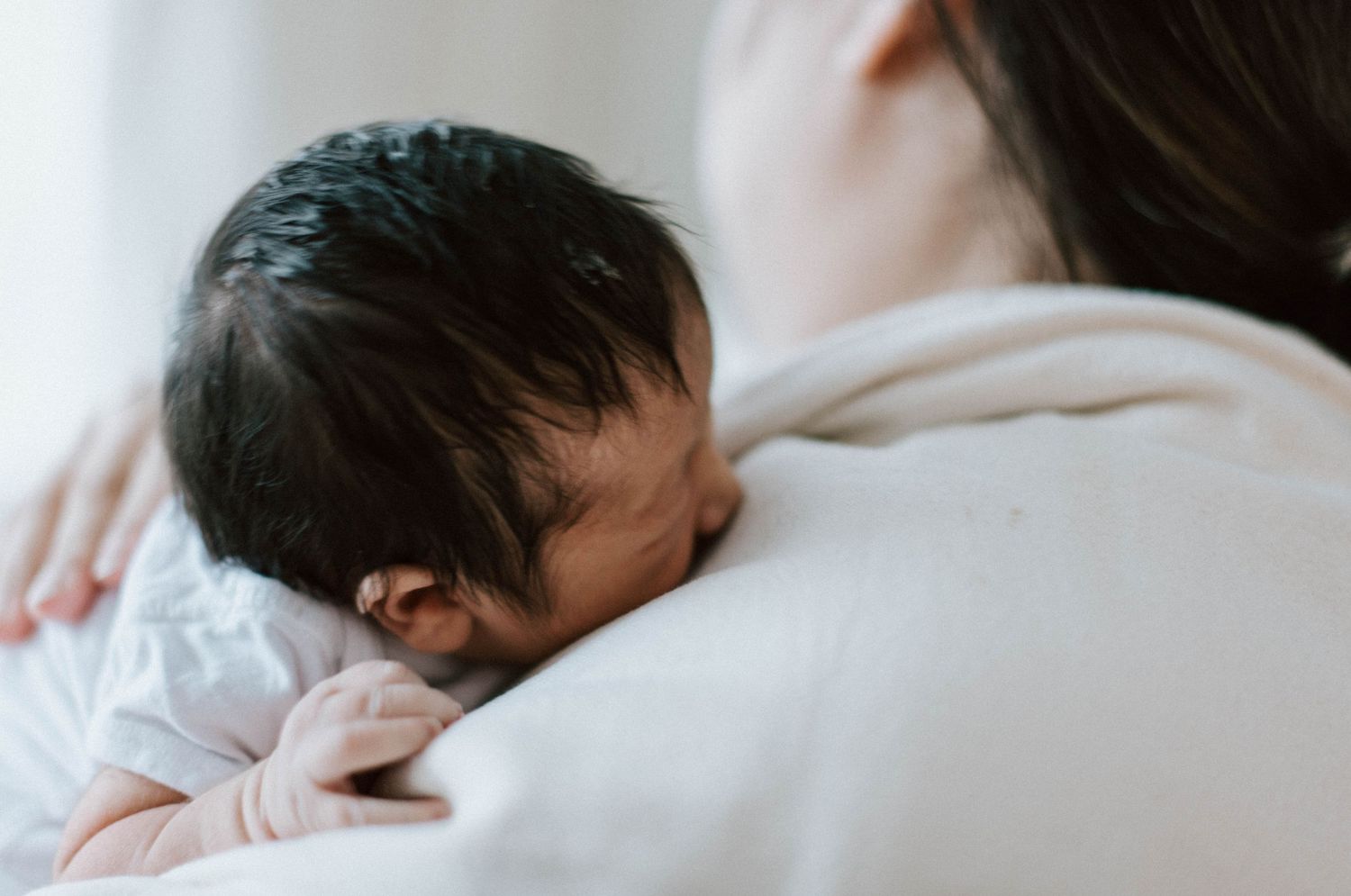Oakville in-home photographer burping baby after a feed