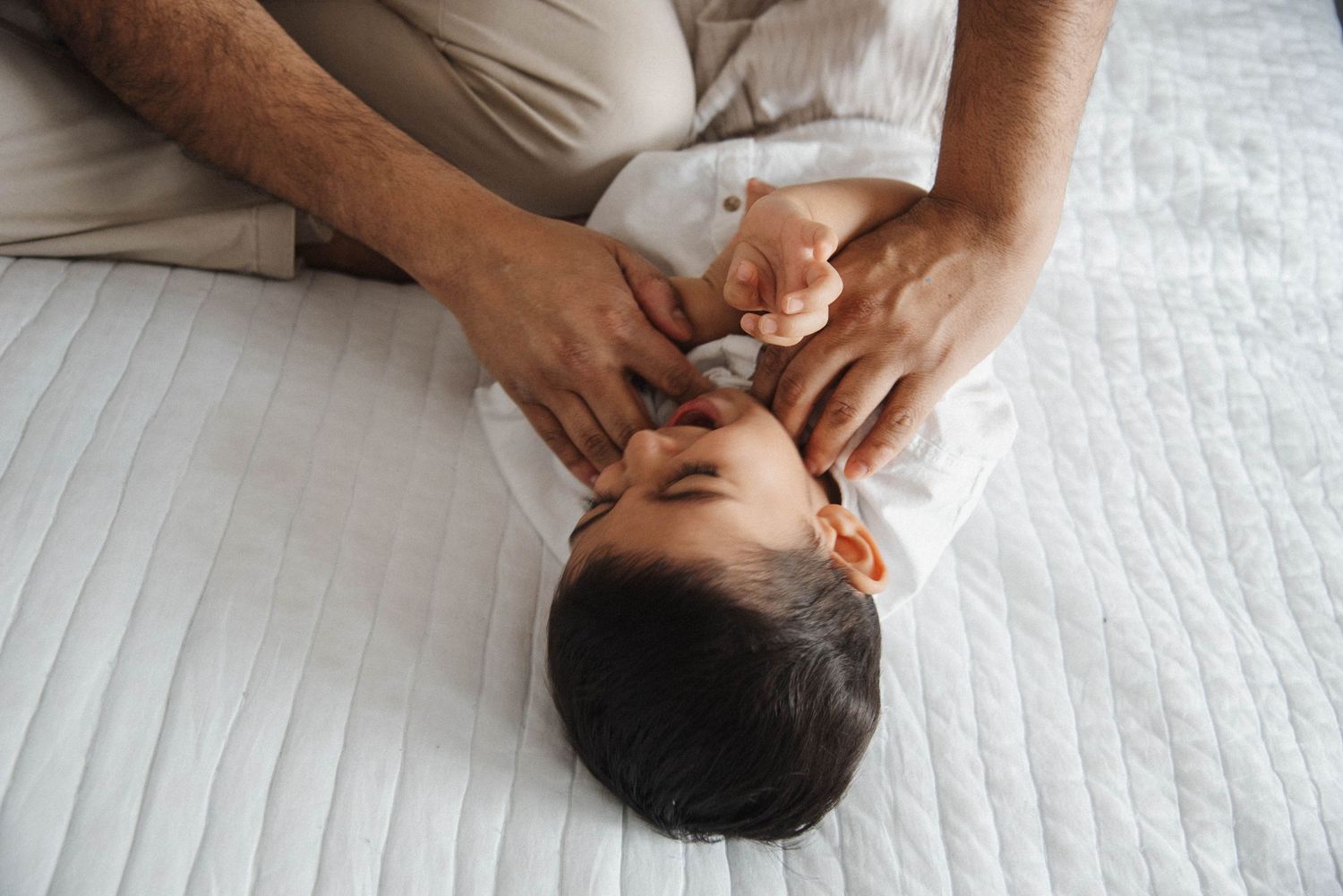 Mississauga family photography portrait focusing on real, unposed moments of dad tickling son