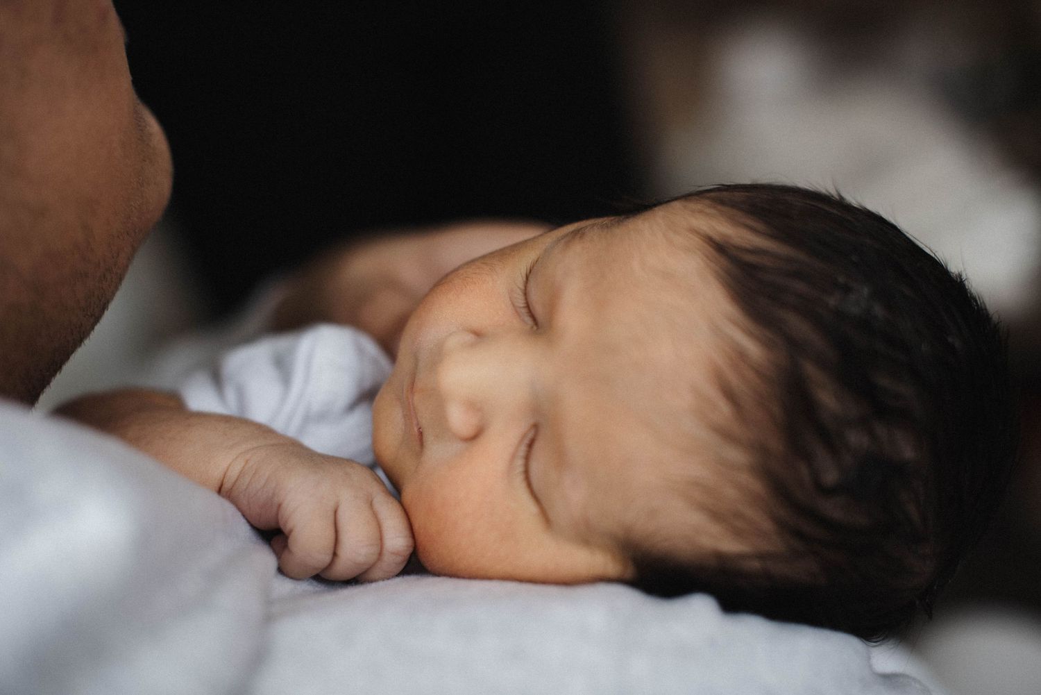 Mississauga in-home newborn photography of baby resting on shoulder