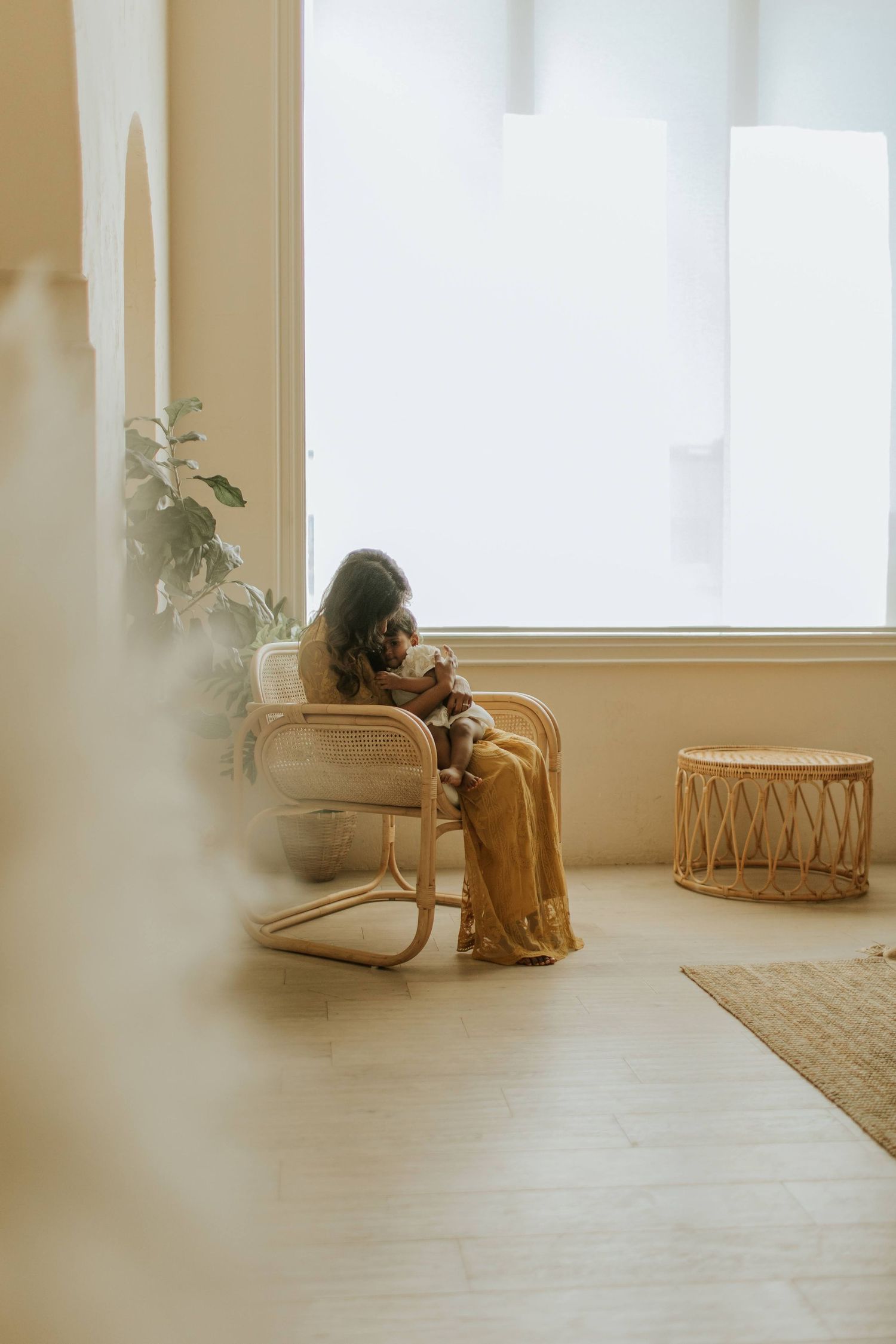 Lifestyle photograph of Ara Pereira interacting with her children at home