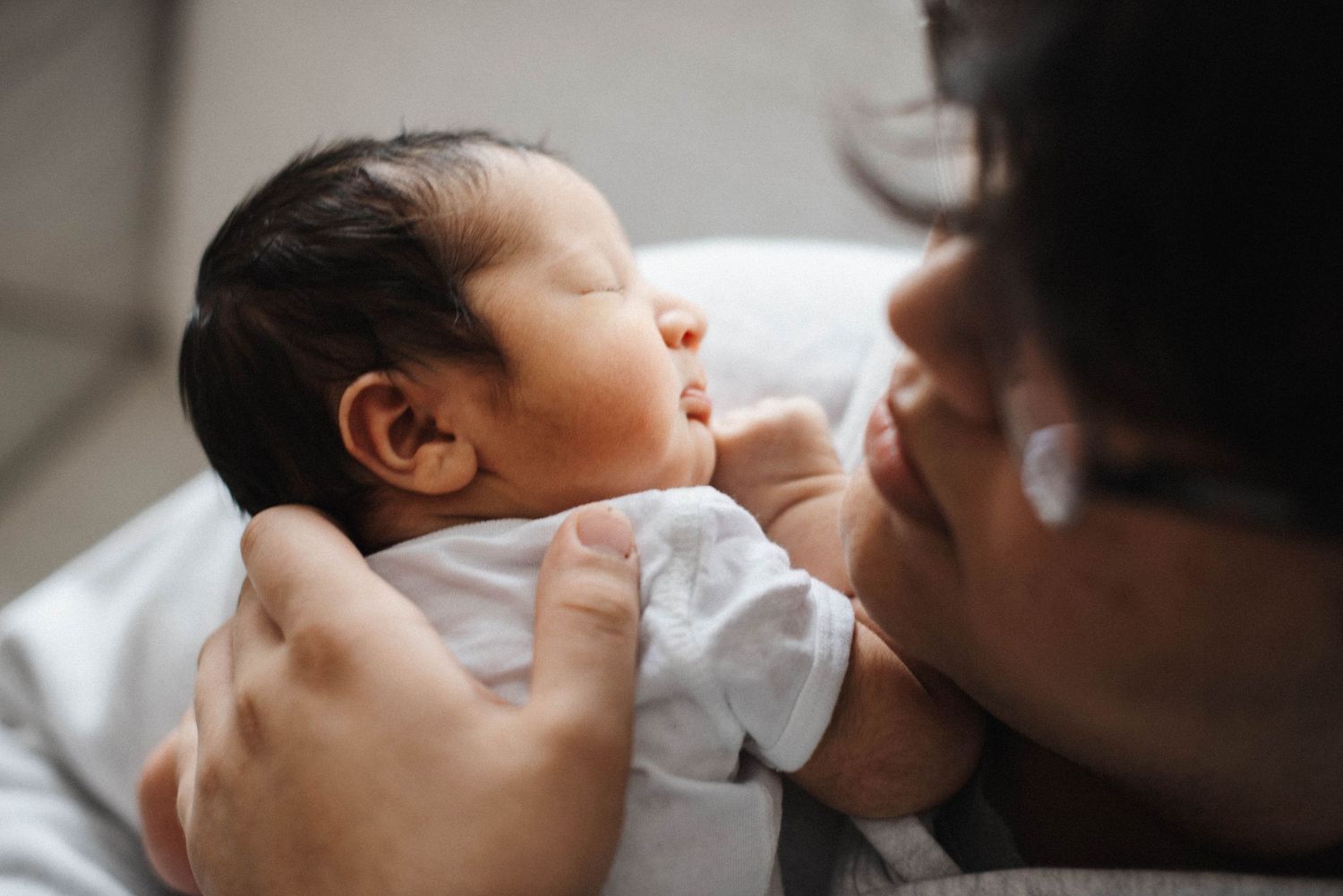 Oakville newborn and family photographer capturing sibling connection at home