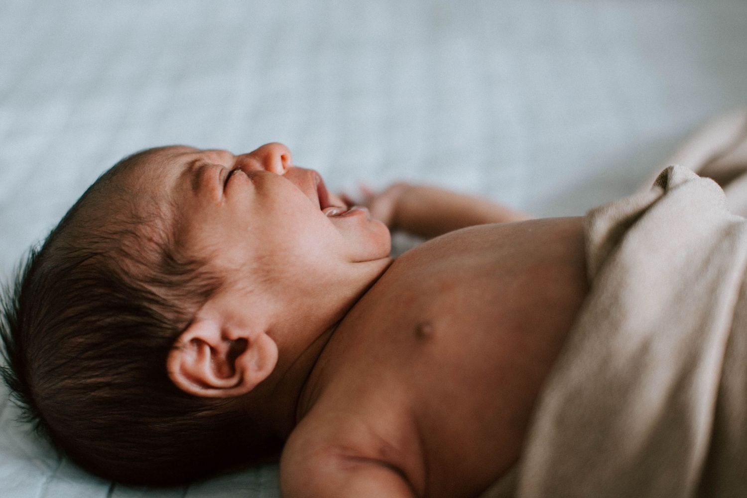 Oakville lifestyle photographer capturing baby crying