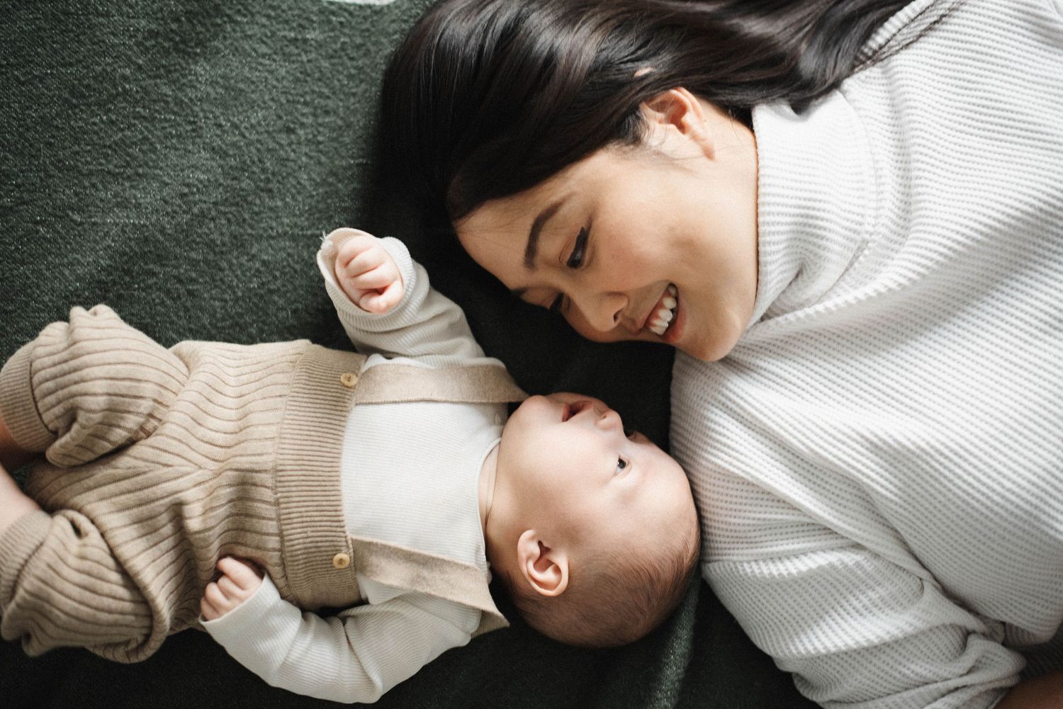 Oakville photographer capturing gentle laugh between mom and baby