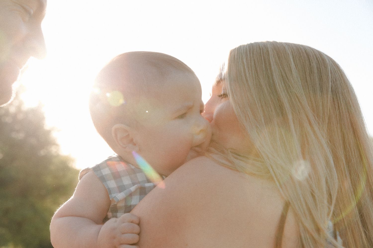 Mother embracing baby boy at sunrise in the Texas Hill Country.