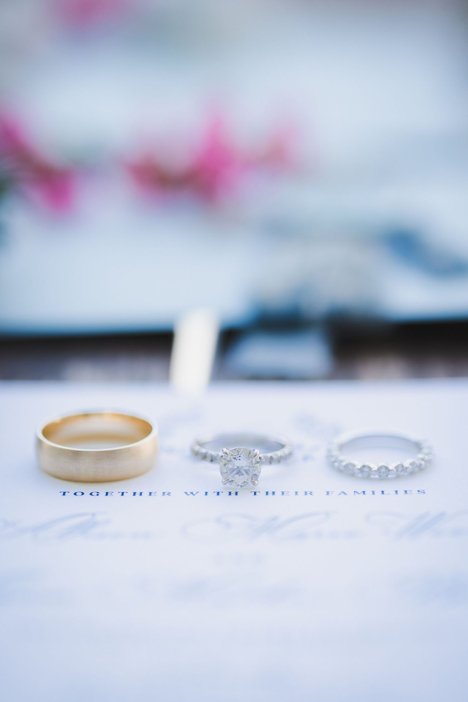 Groom's ring, bride's engagement ring, and diamond wedding band details