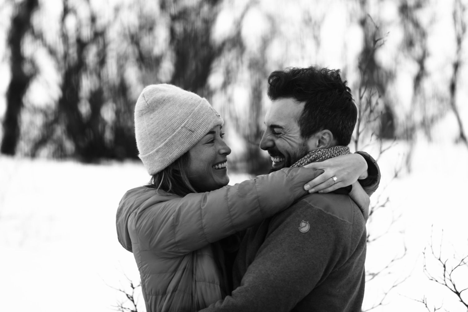Woman hugging her new fiancé after their engagement in Arctic Sweden.
