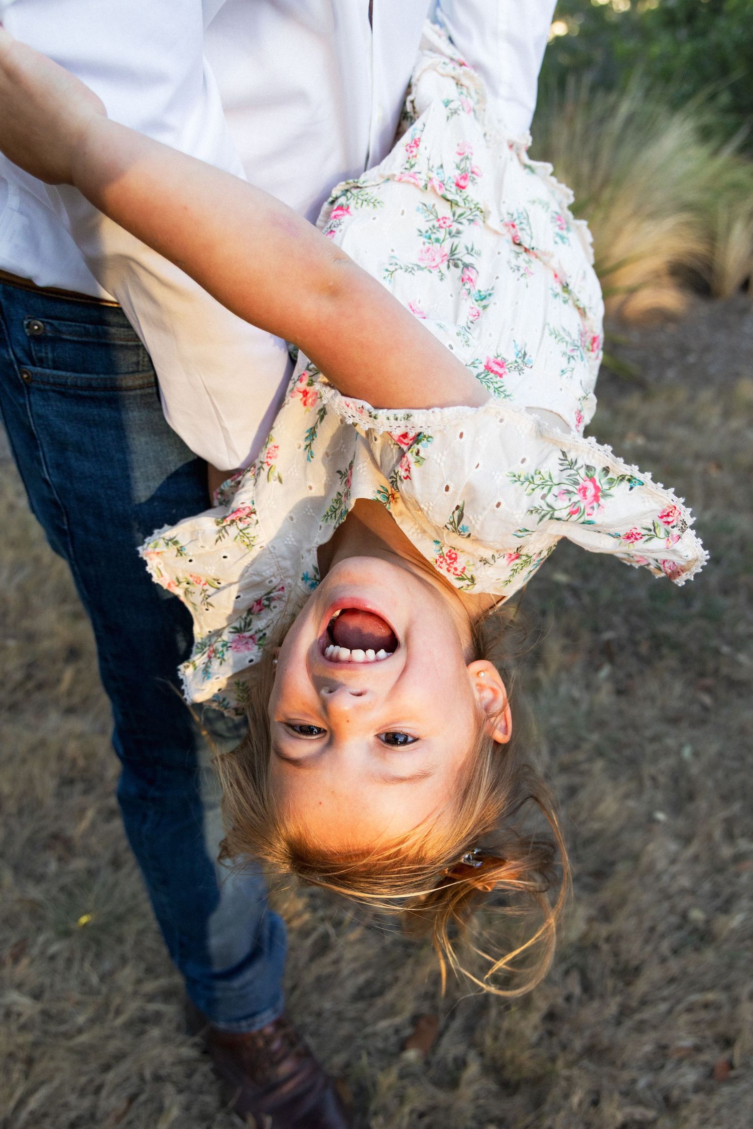 Little girl plays with dad during sunset family photography session | Texas Hill Country