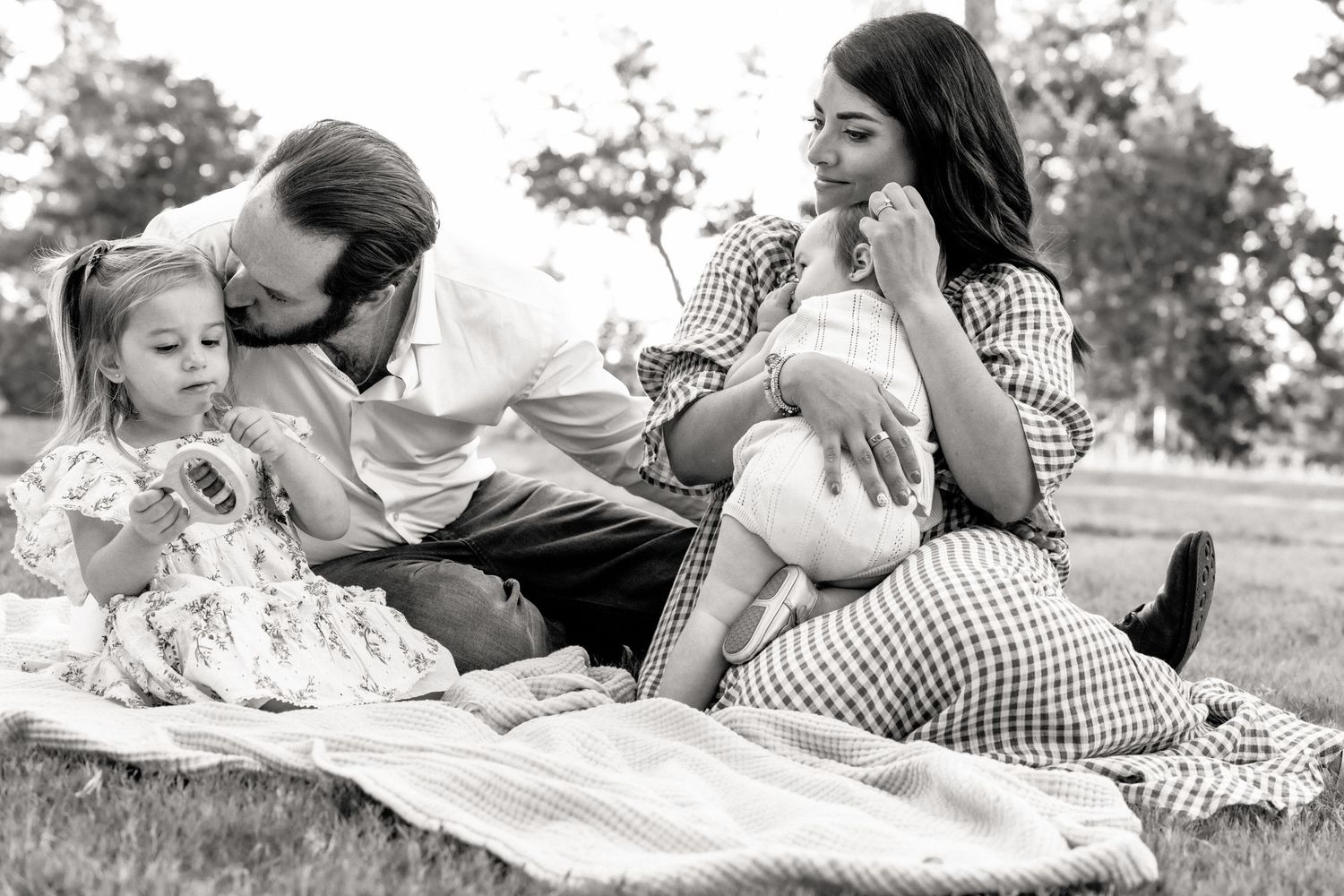 Family embraces naturally during candid family photo session | Candid family photography | Dripping Springs, Texas