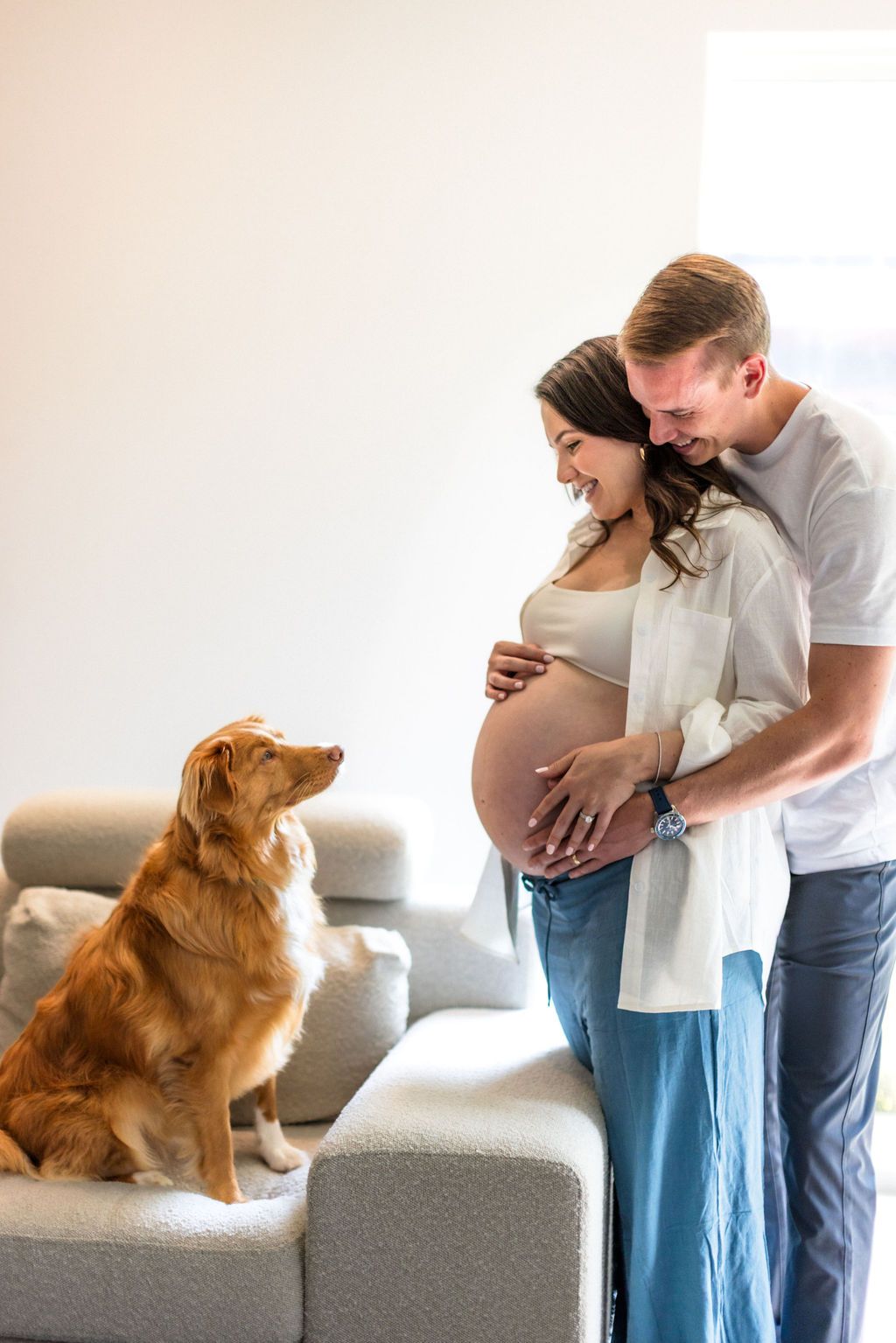 Beautiful couple plays with their puppy during at-home maternity session | 37 weeks pregnant